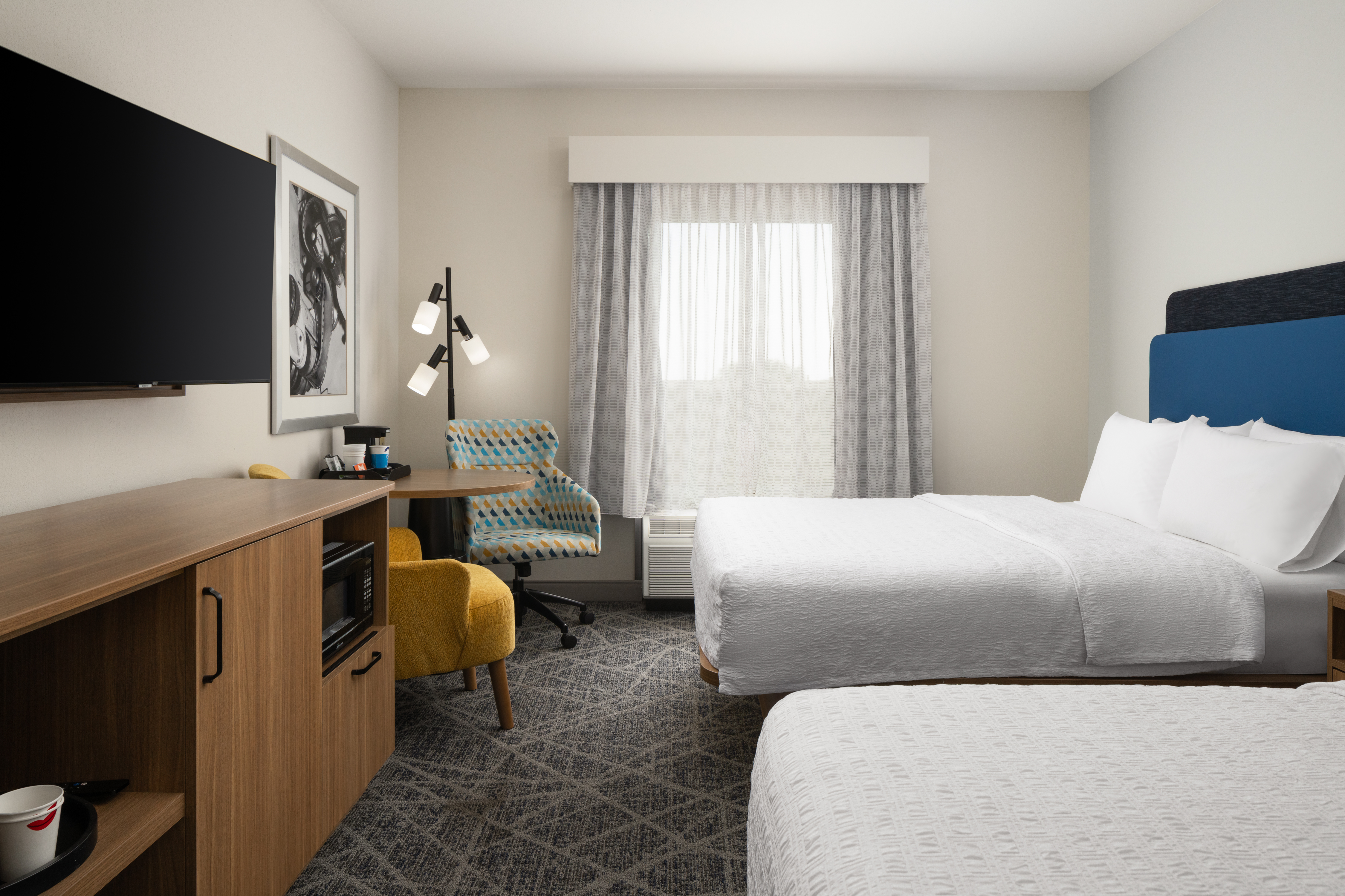 Queen Double Bedroom with Two Beds, TV, Mini Microwave, Floor Lamp, Work Desk and Two Chairs