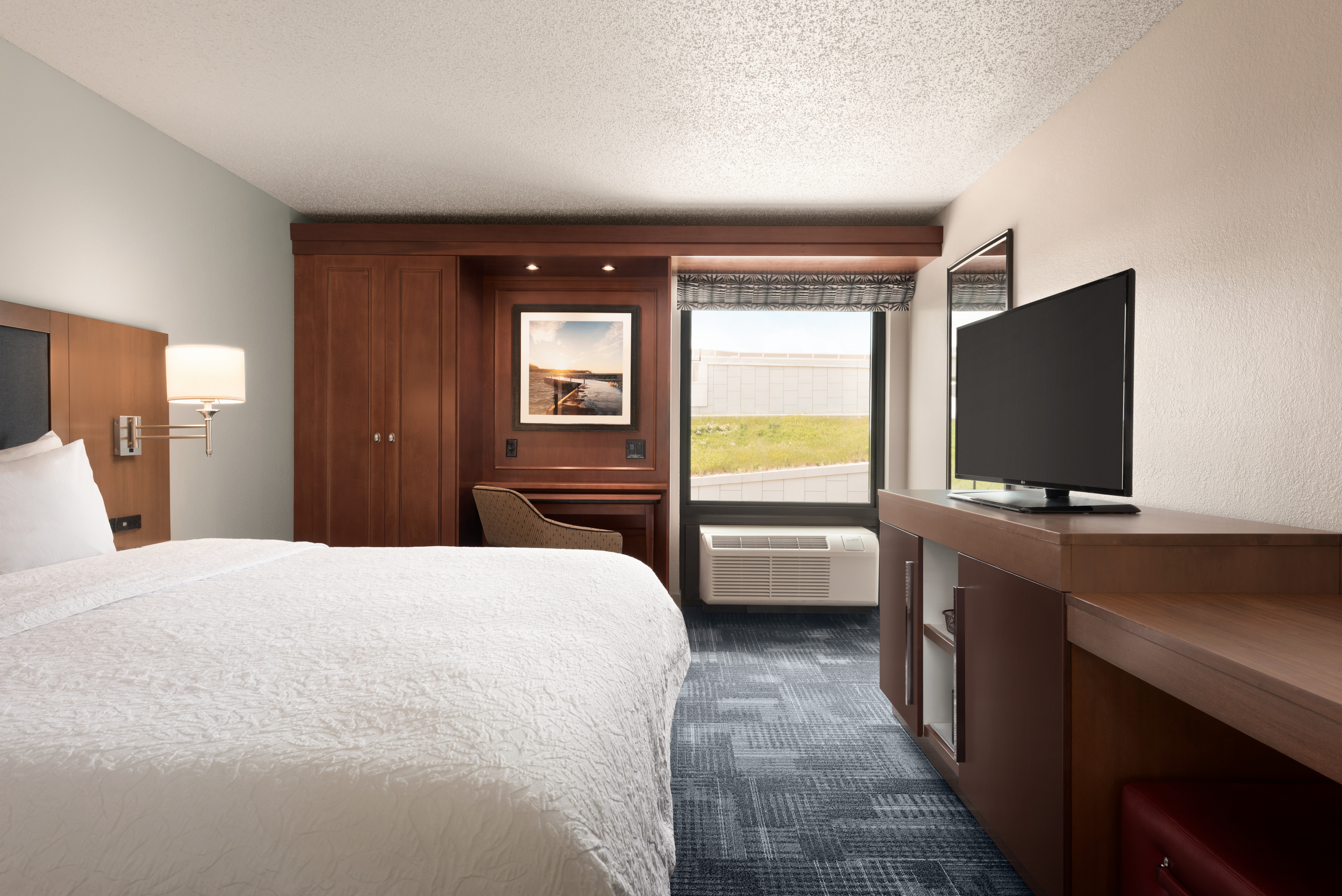 King Bed Guest Room with desk and tv