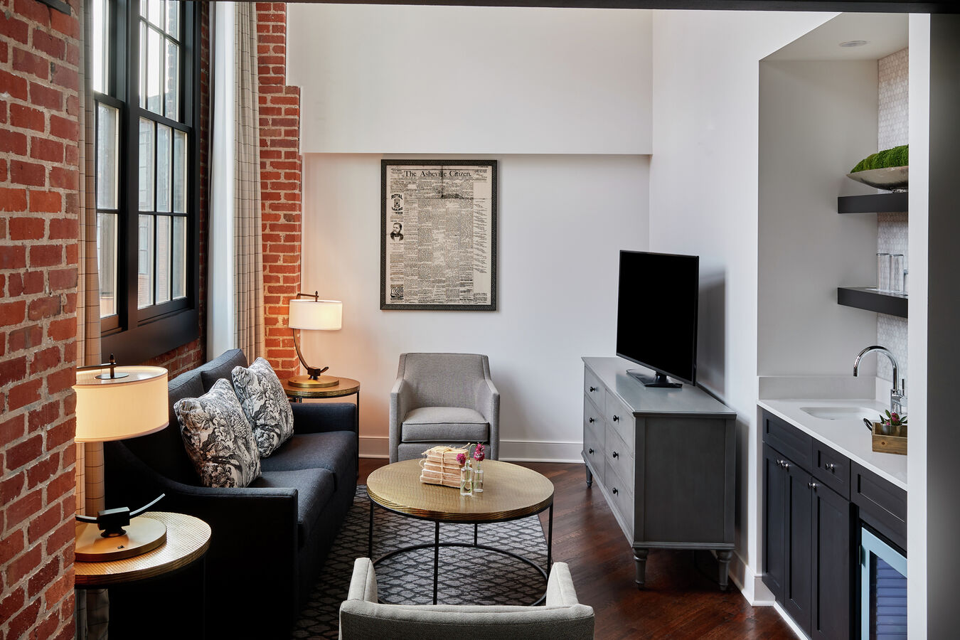 Living area in room with TV and chairs
