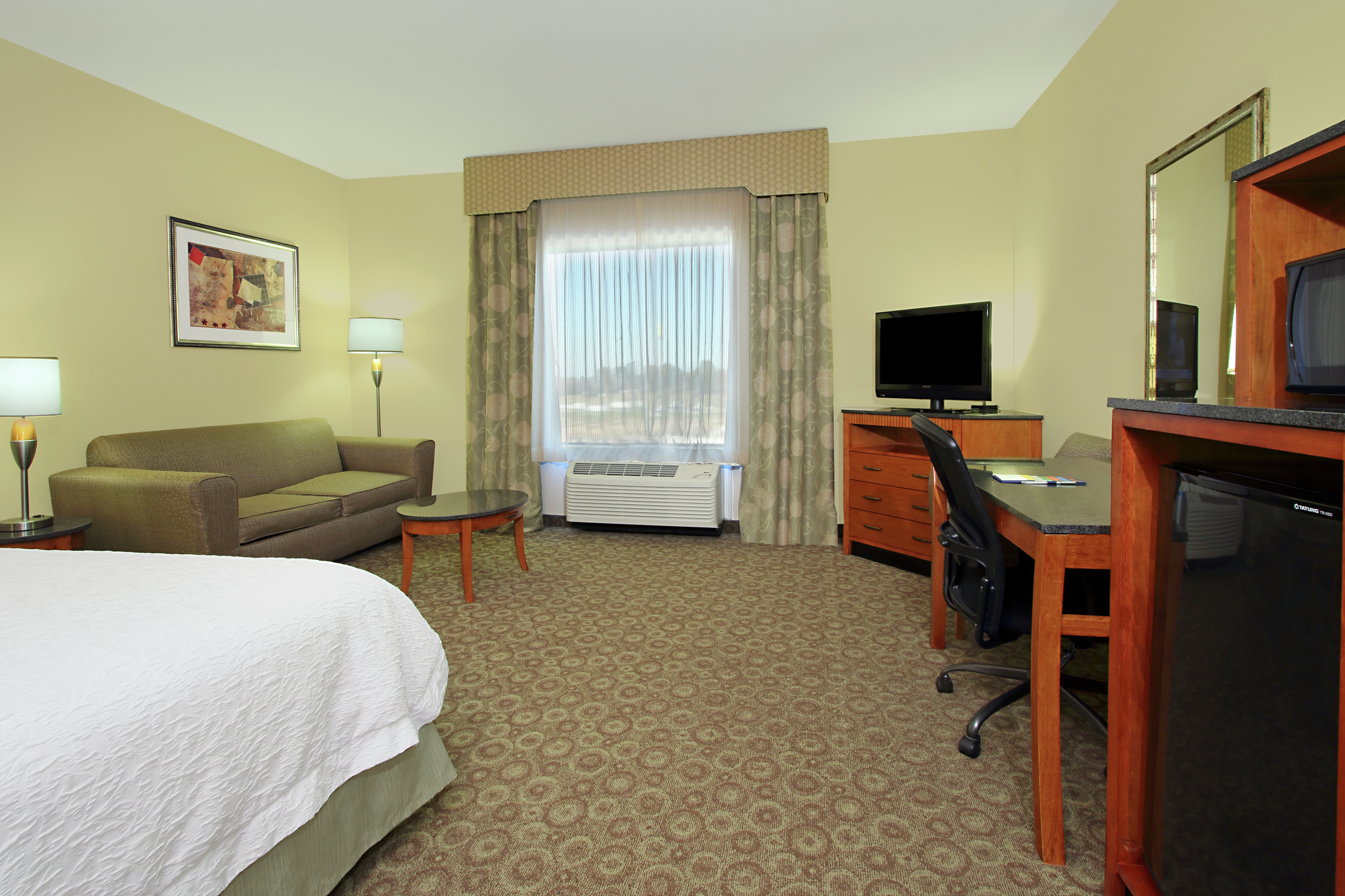 Guestroom with King Bed, Lounge Area with Sofabed, Work Desk, Kitchenette, and Room Technology