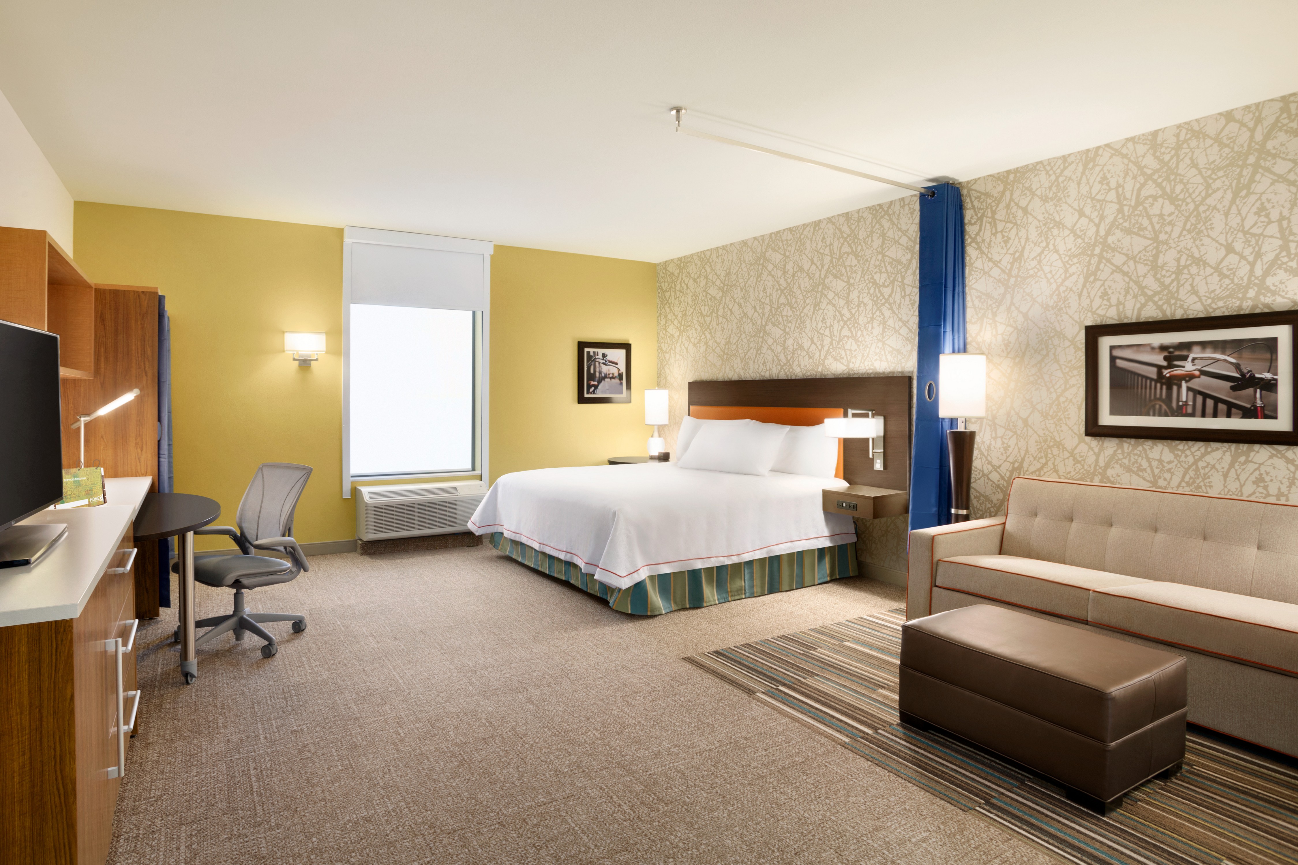 One King Bed Guestroom with HDTV, Work Desk, Sofa and Footrest