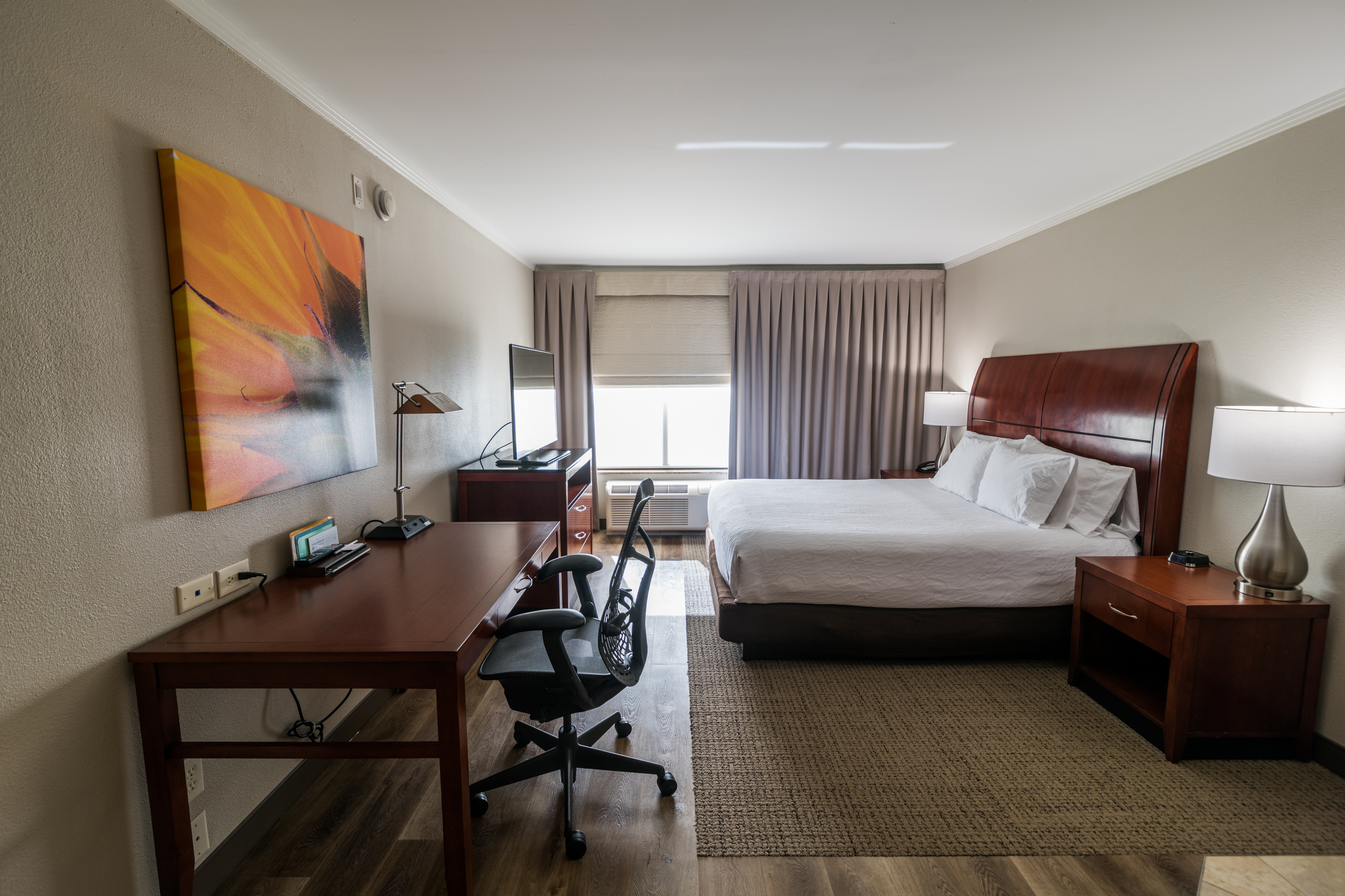 King Bed and Work Desk in Guest Room With Whirlpool