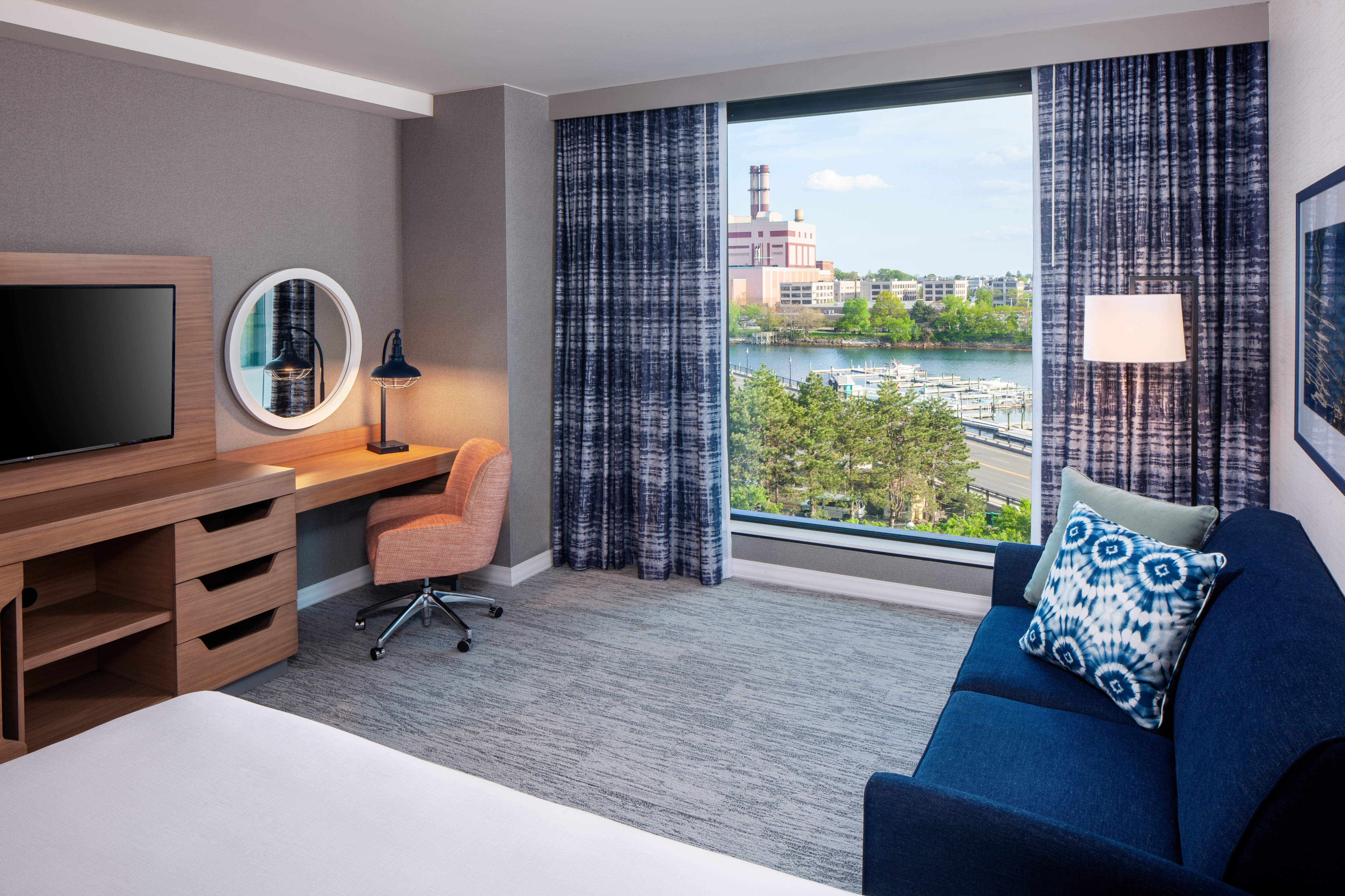 king room with sofabed and desk with view