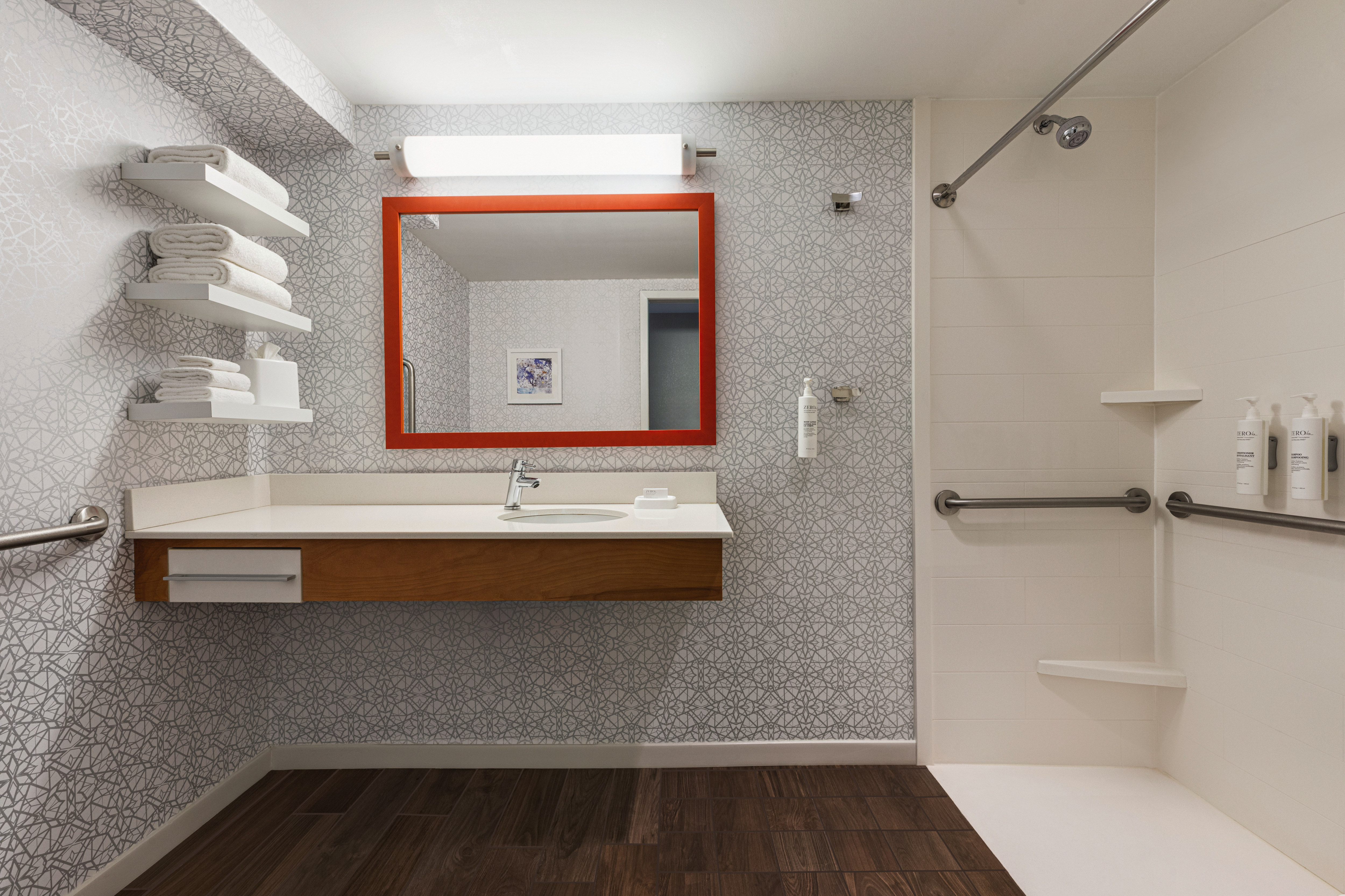 Spacious accessible bathroom featuring a roll-in shower and large vanity