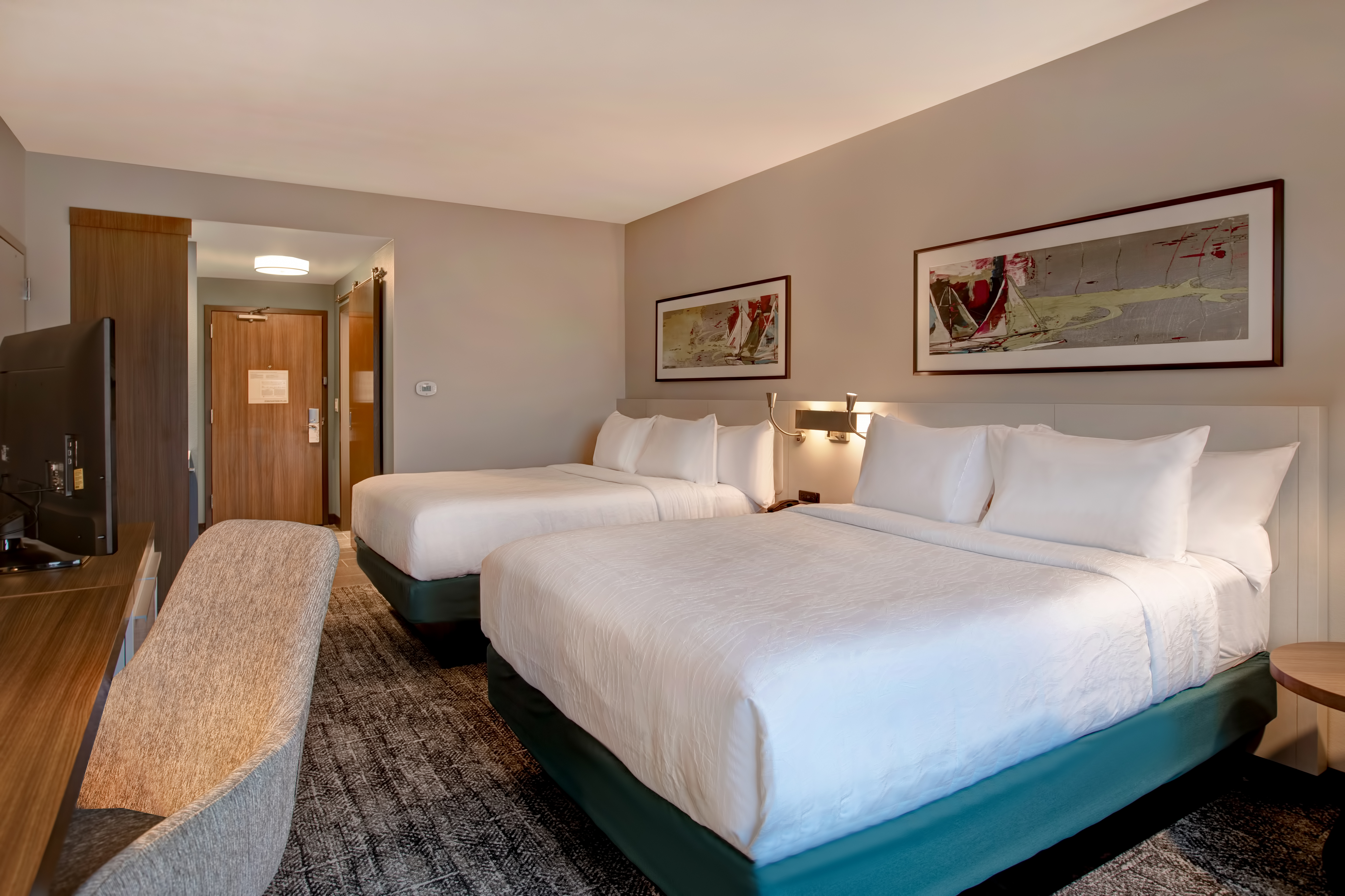 guest bedroom with two beds and television