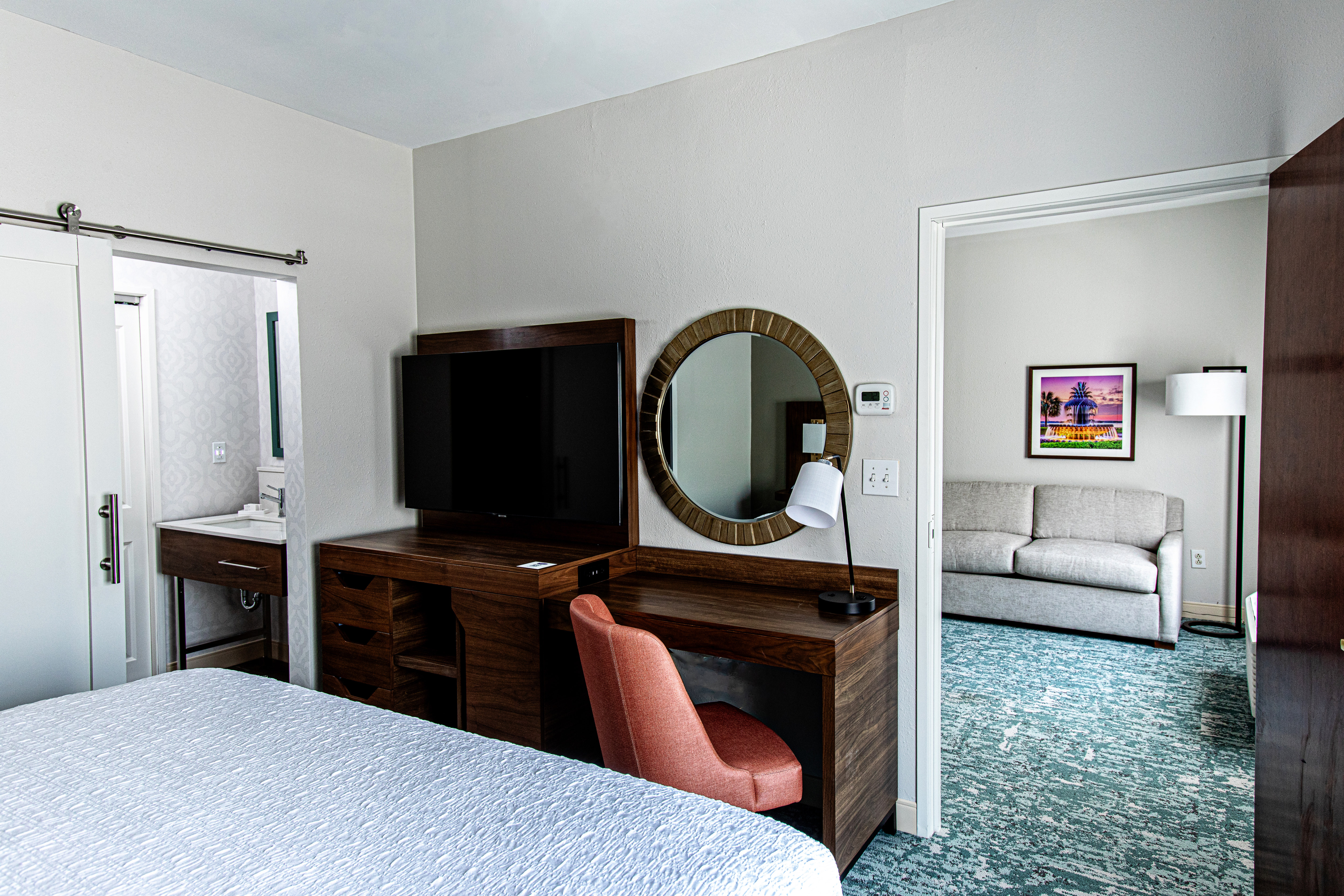 guest suite bedroom, bathroom entrance, tv, sofa