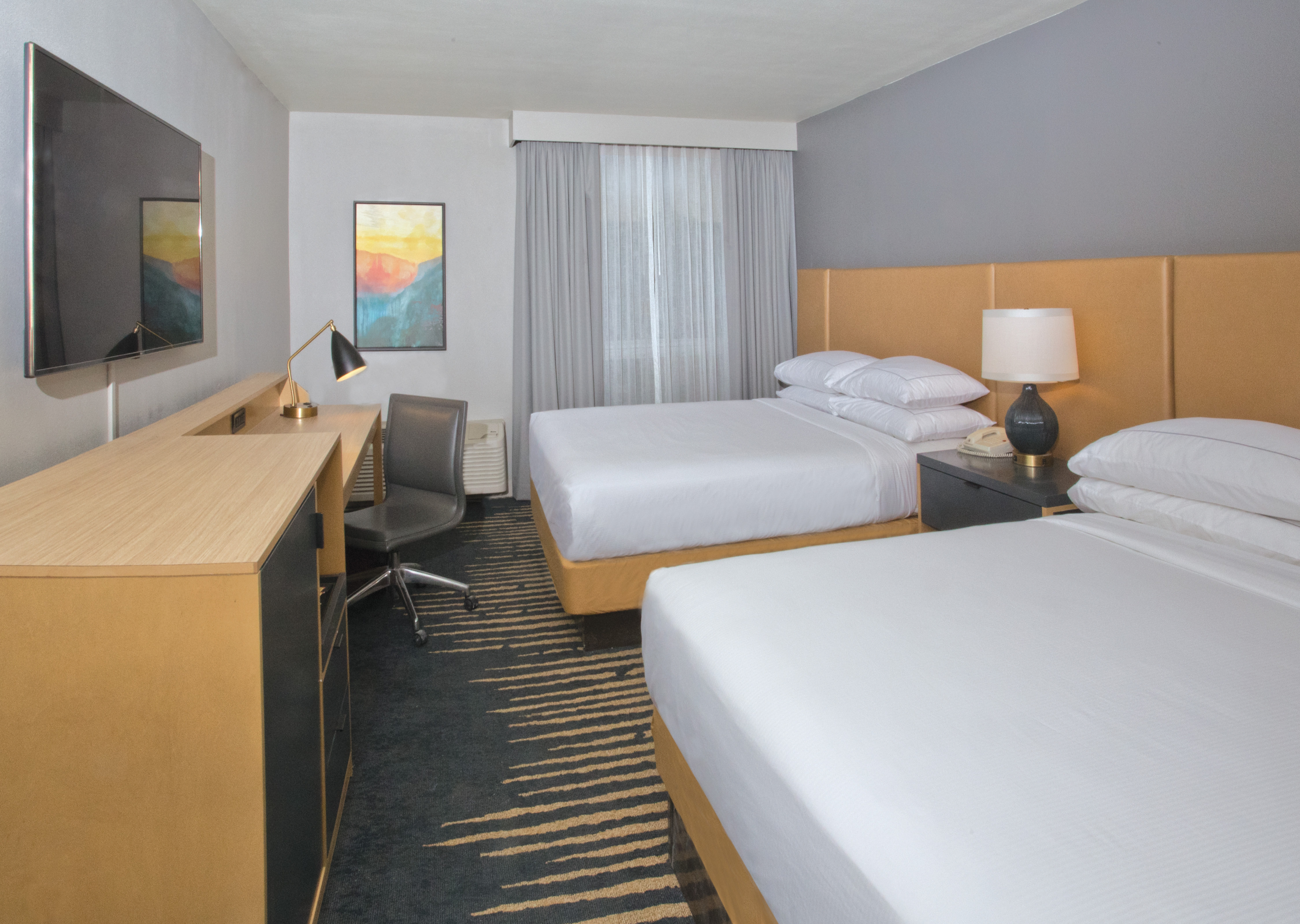 Two Beds Desk HDTV in Hotel Guest Room