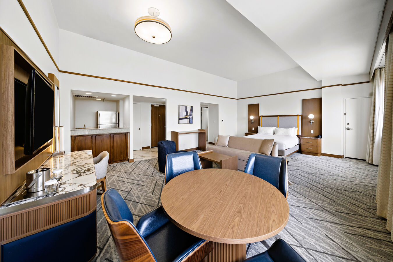Suite with Dining Table, Wet Bar, TV, Sofa, and Bed
