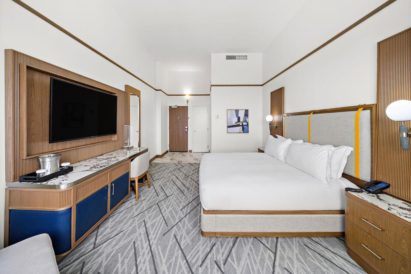Guest Room with King Size Bed, Work Desk, Chair, and Wall TV