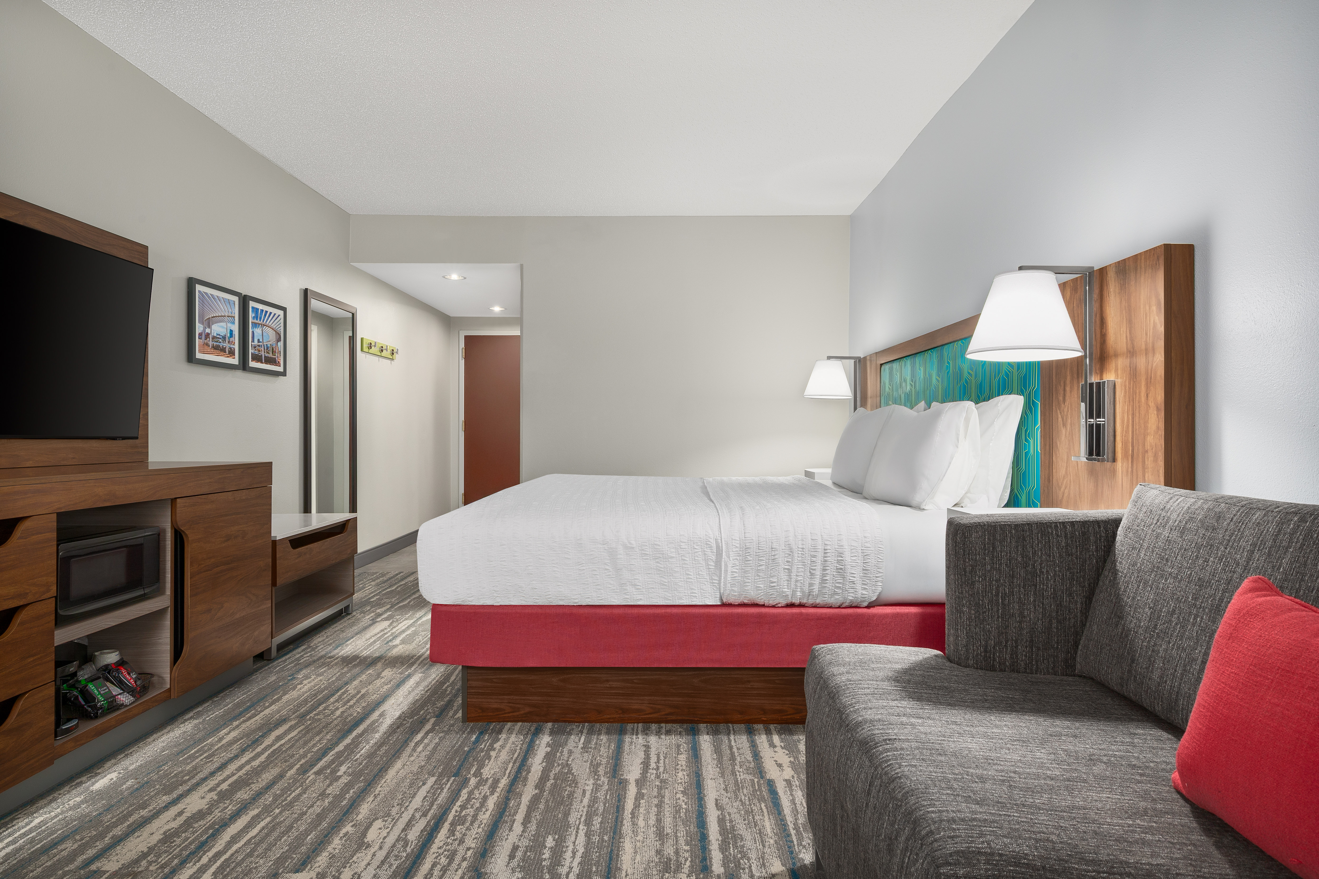 Large Bed, TV, Microwave and Sofa in a Guest Room
