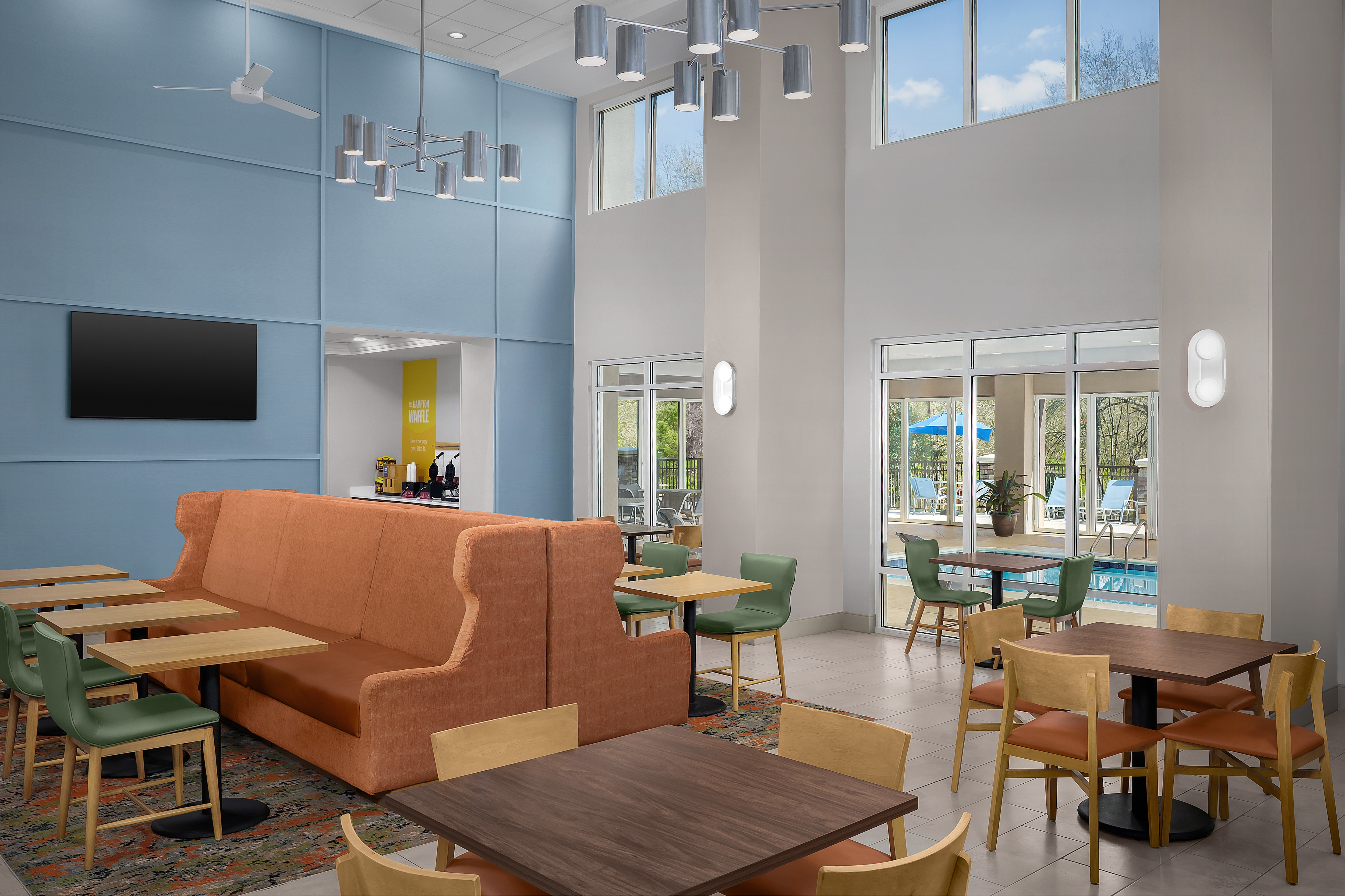 Dining Area with TV in Hotel Lobby with Pool View