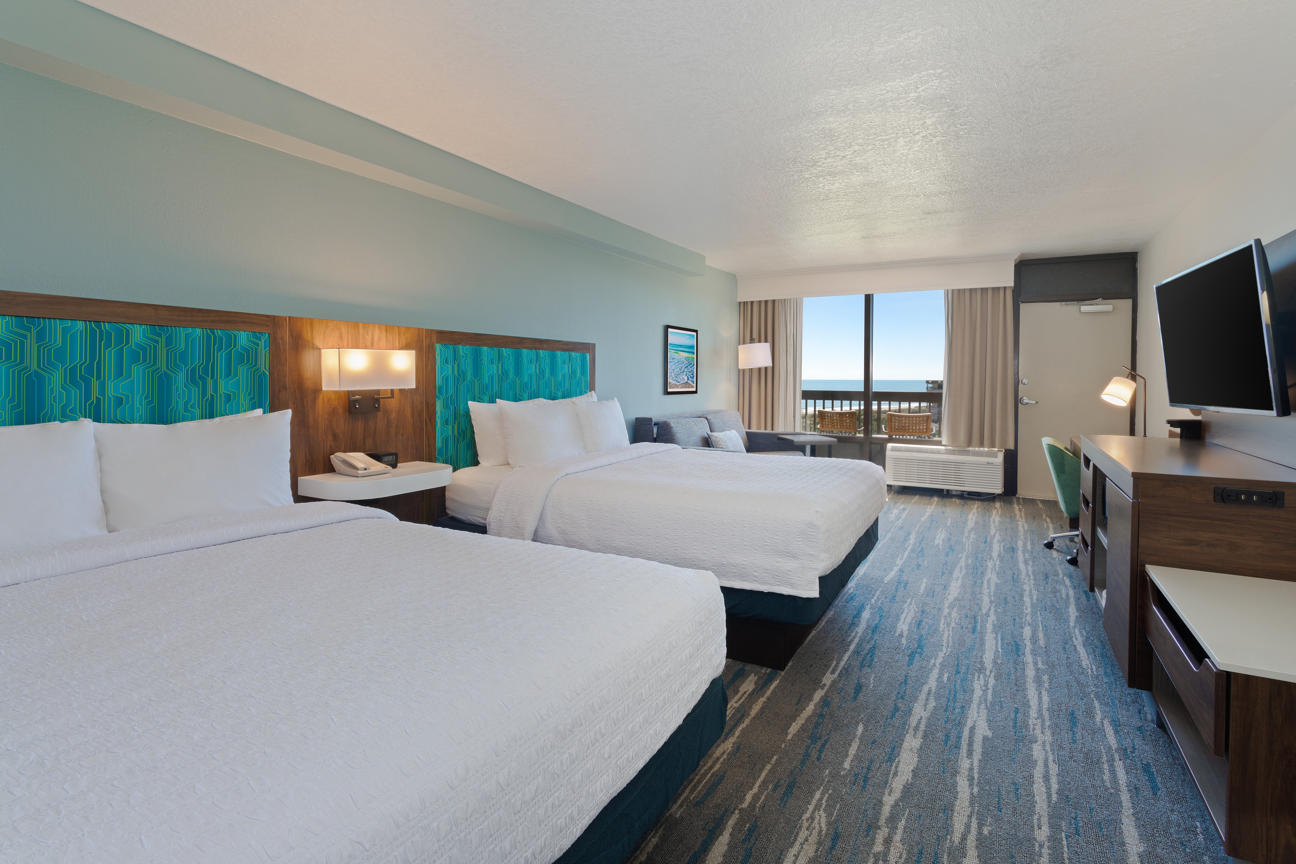 guest room, 2 queen beds, tv, window view of the ocean