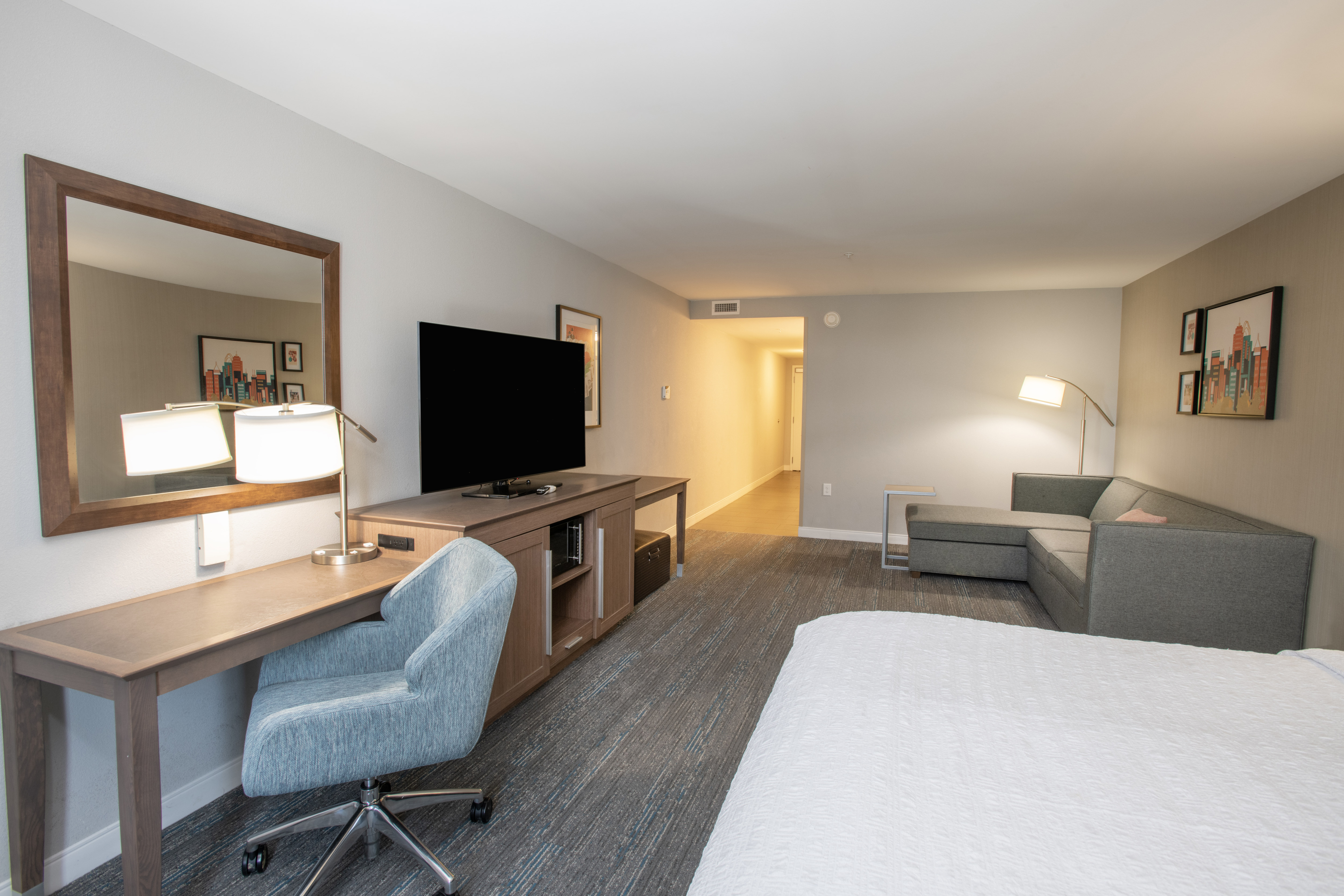 Large Bed, HDTV, Desk and Sofa in a Guest Room