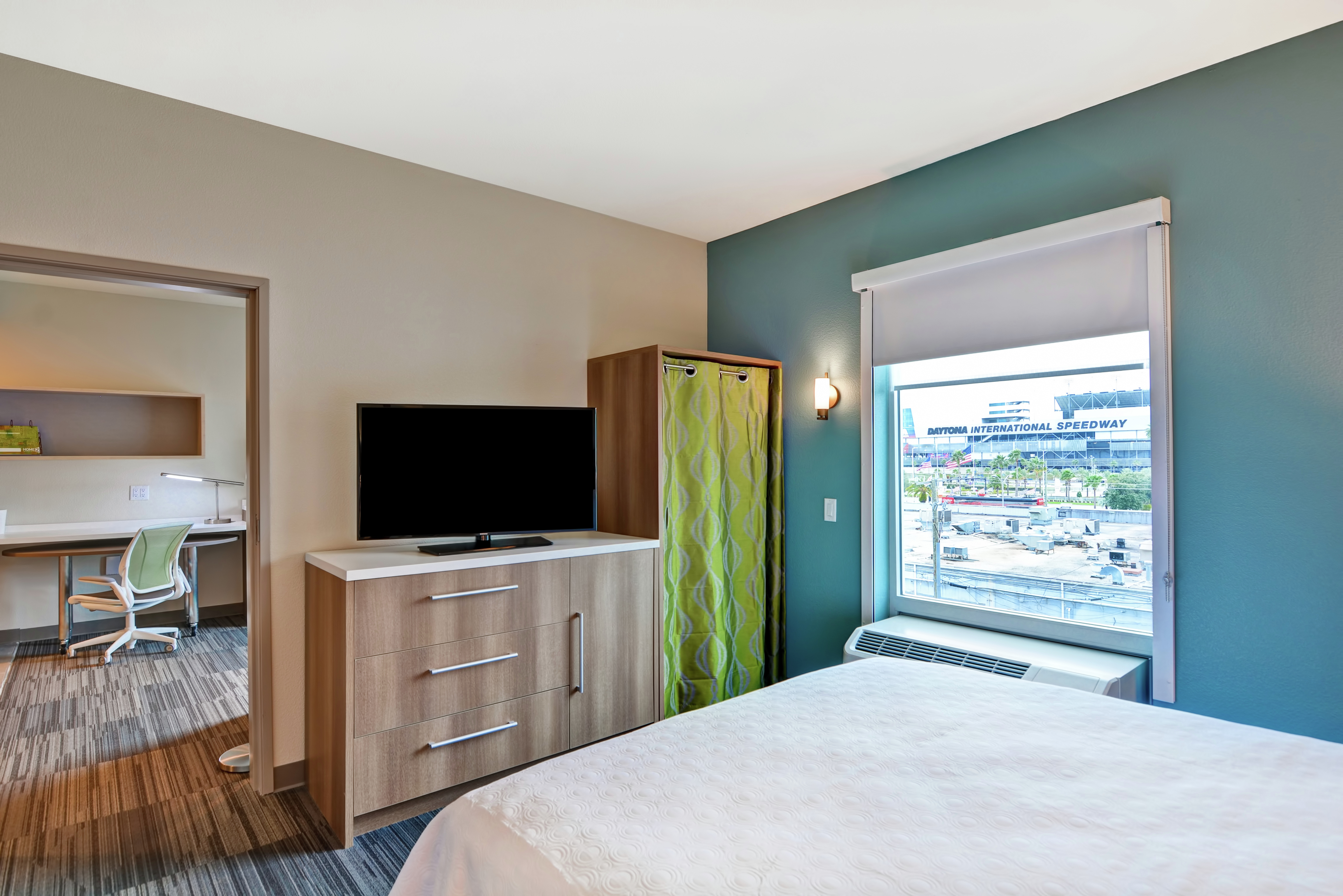 Bedroom Area with Television, Dresser, and Closet