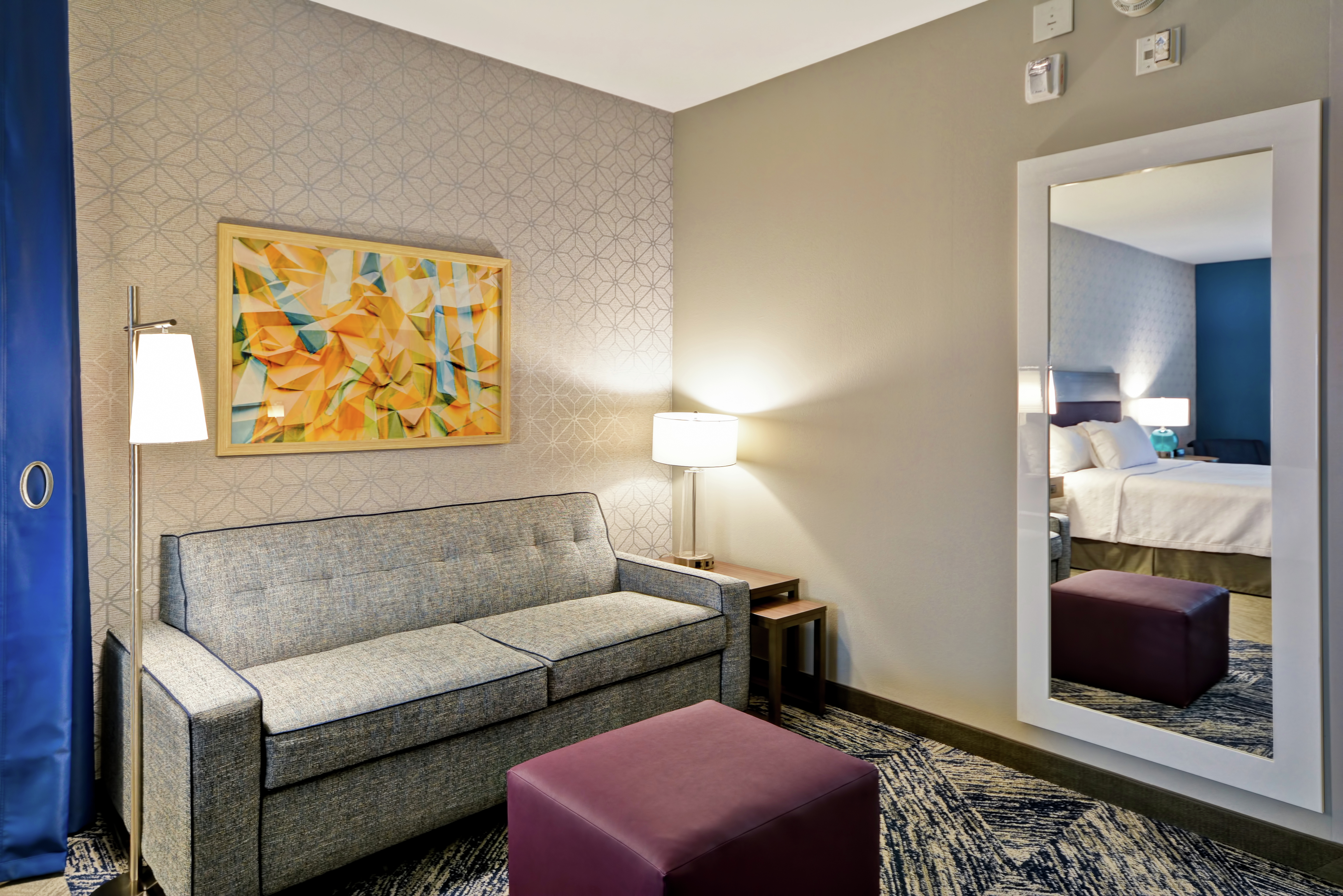 Accessible King Guestroom Suite with Lounge Area, Sofabed, and Mirror