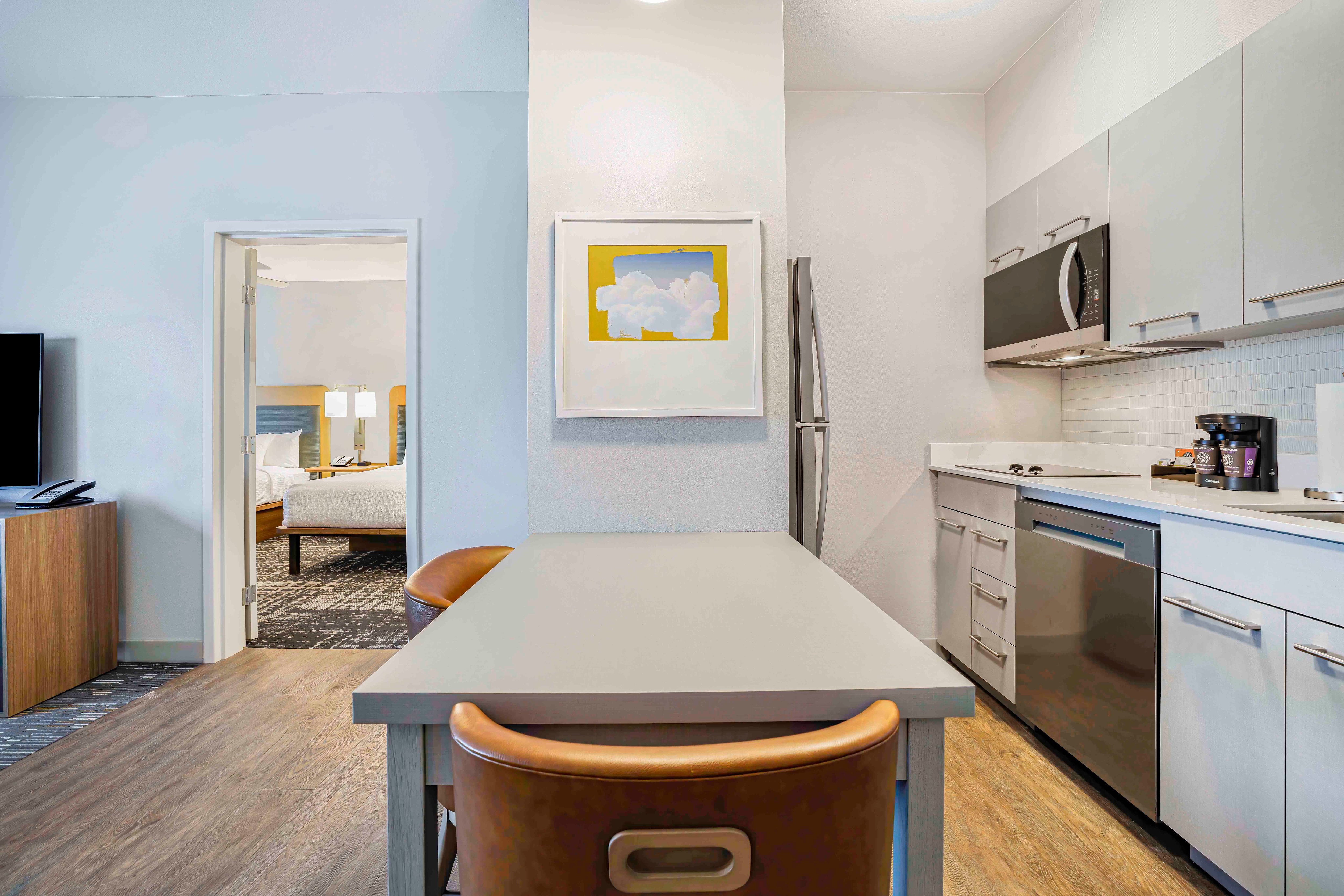 Kitchen area with microwave, sink and TV