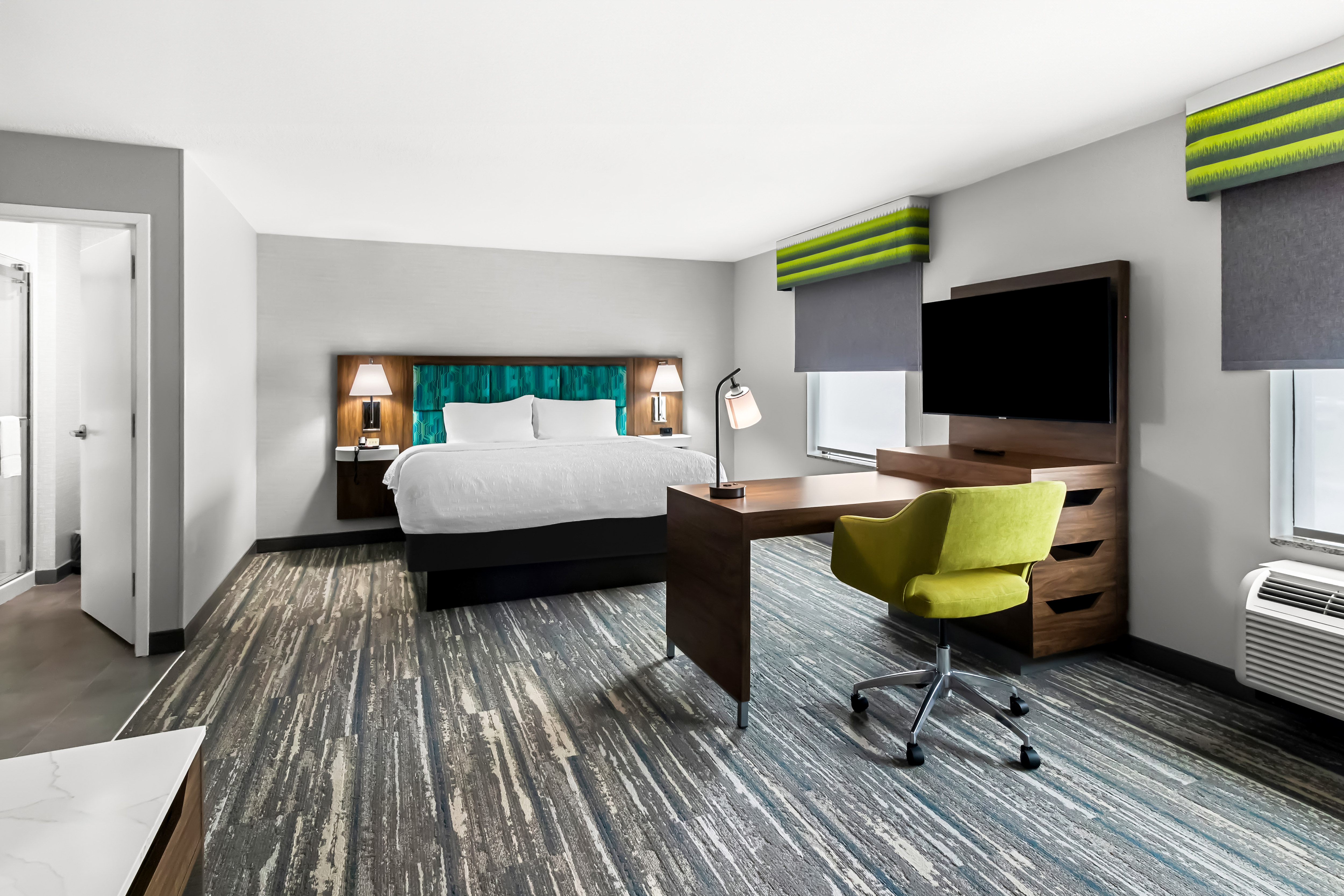 bedroom suite with bed and work desk