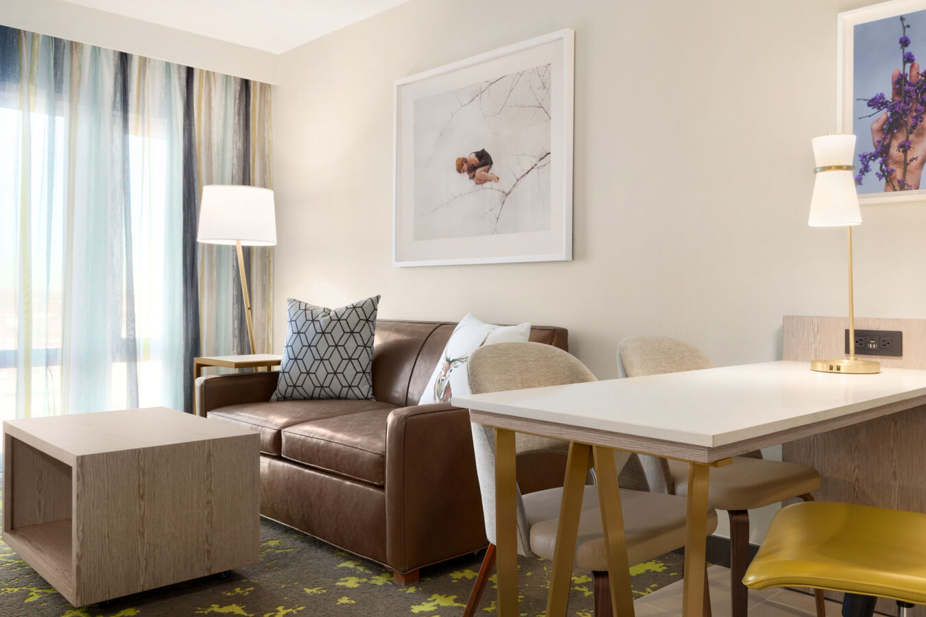 King Room Suite Dining Area and Living Area with Leather Couch, Throw Pillows and a Coffee Table