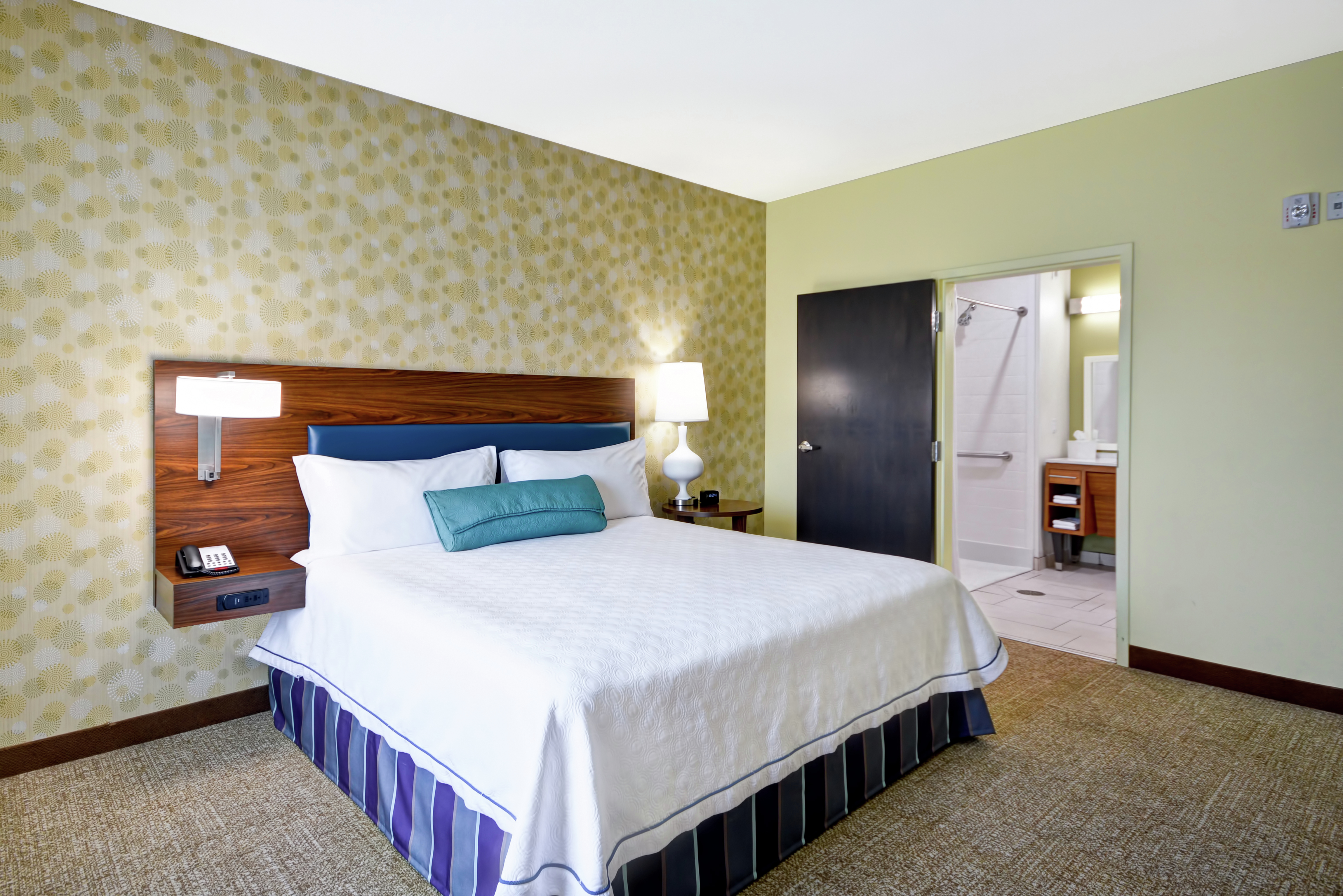 Double bed with bathroom in background