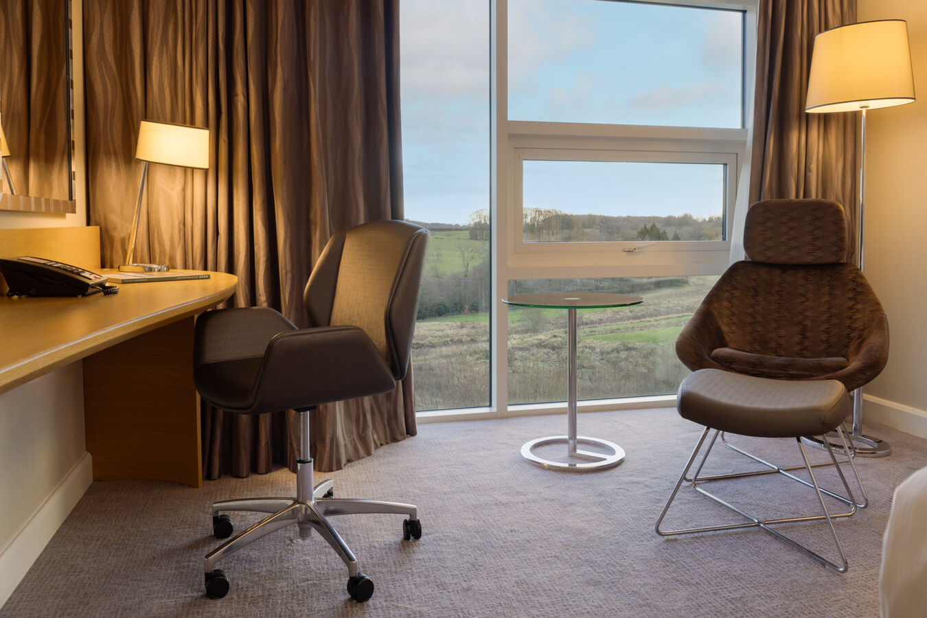 Work Desk and Armchair in a Guest Room with a Large Window