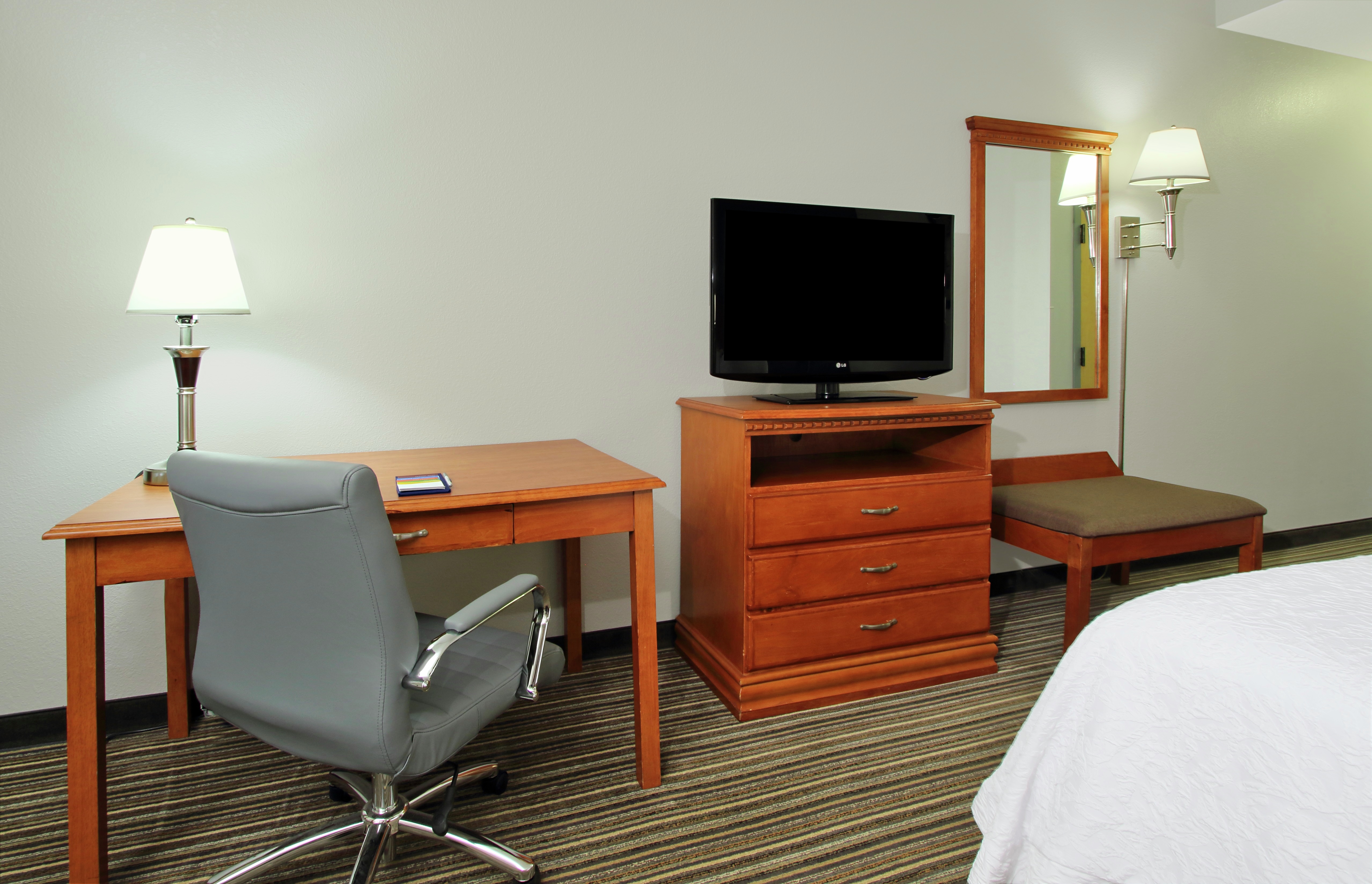 Guest room with work desk and TV.