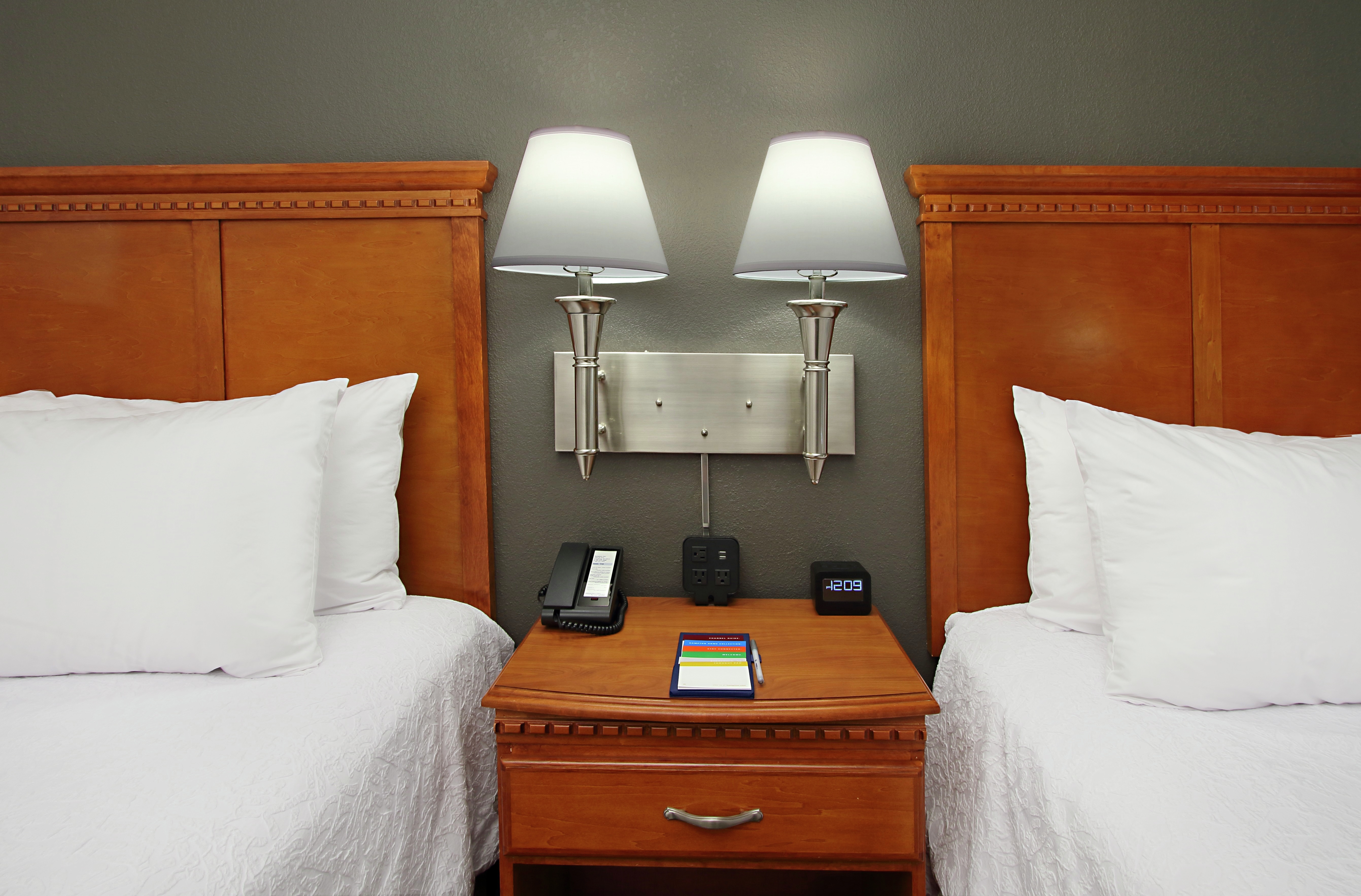 Guest room with two beds and nightstand.