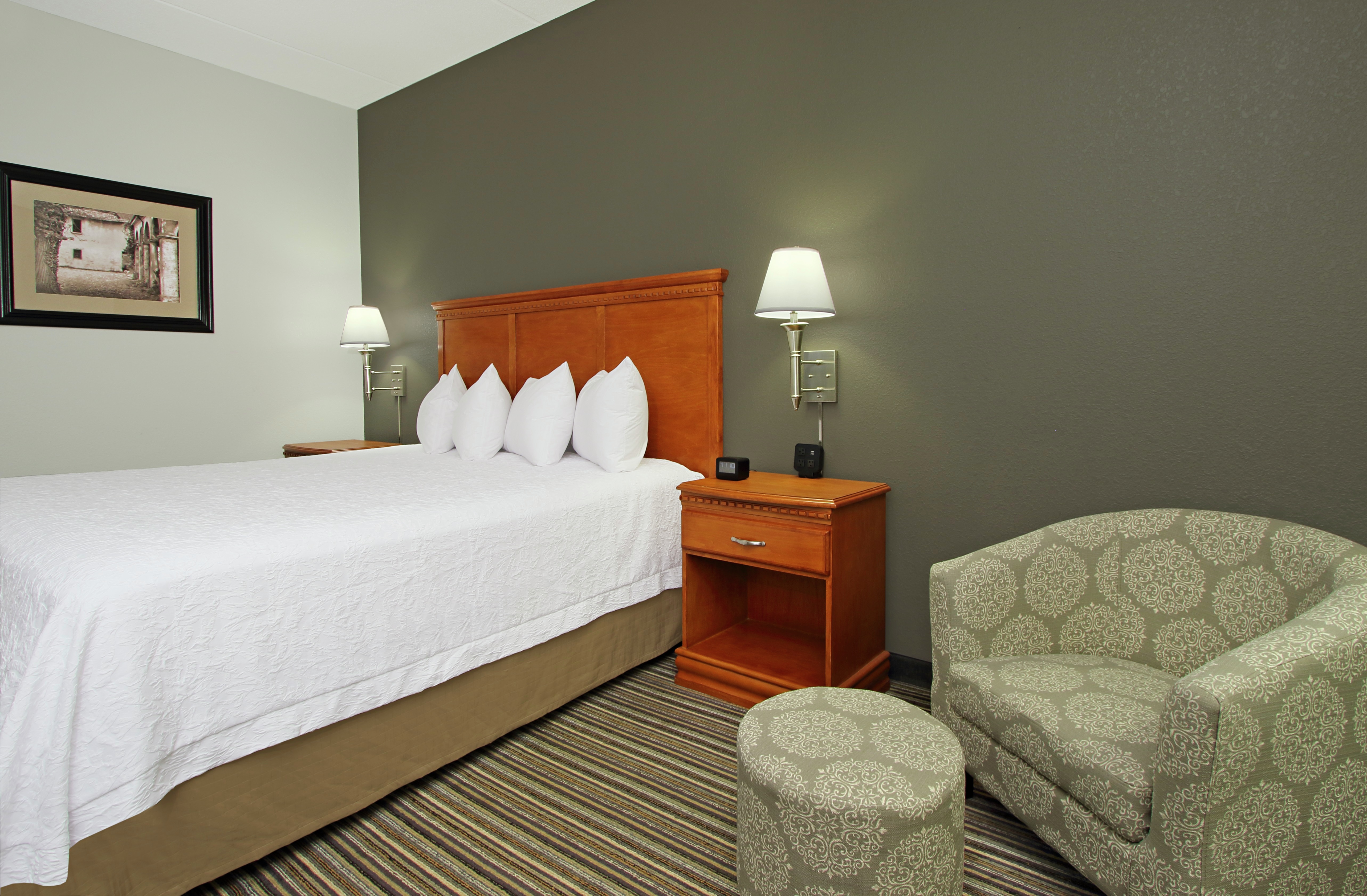 Guest room with bed and lounge area.