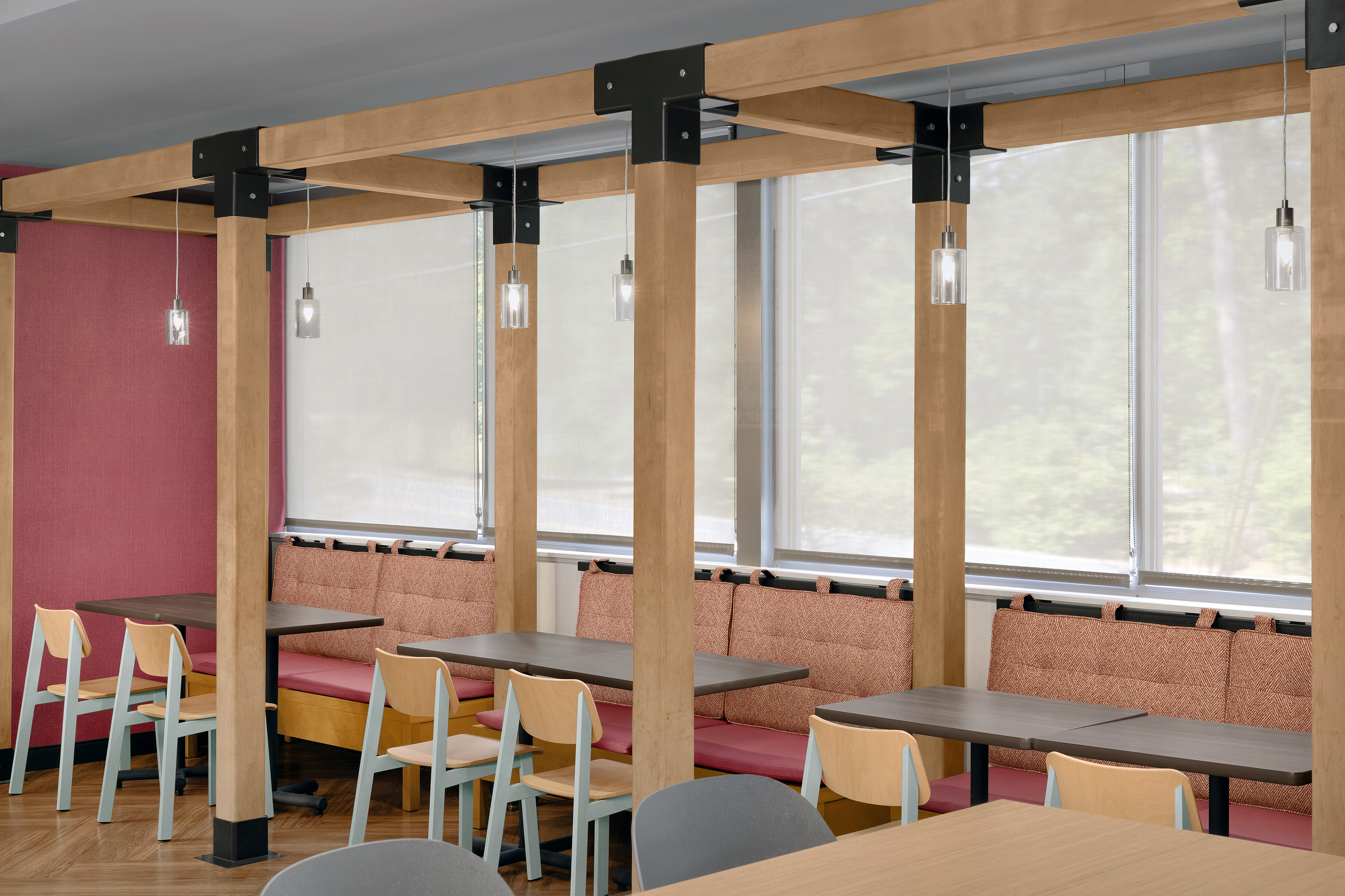 Seating in breakfast area with warm lighting and upholstered benches.