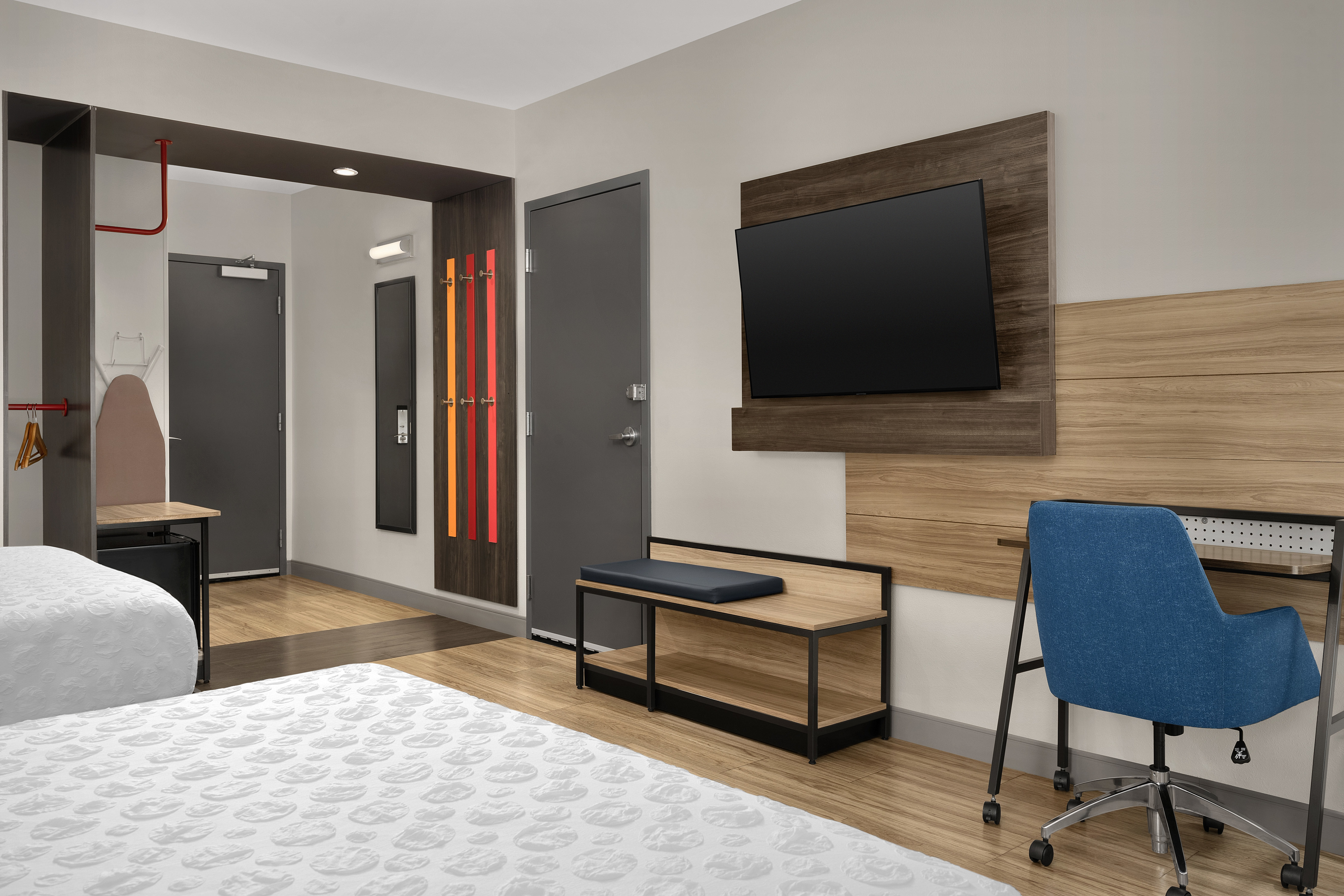 Spacious accessible room with wooden floors, two queen beds, flat screen tv and desk with chair