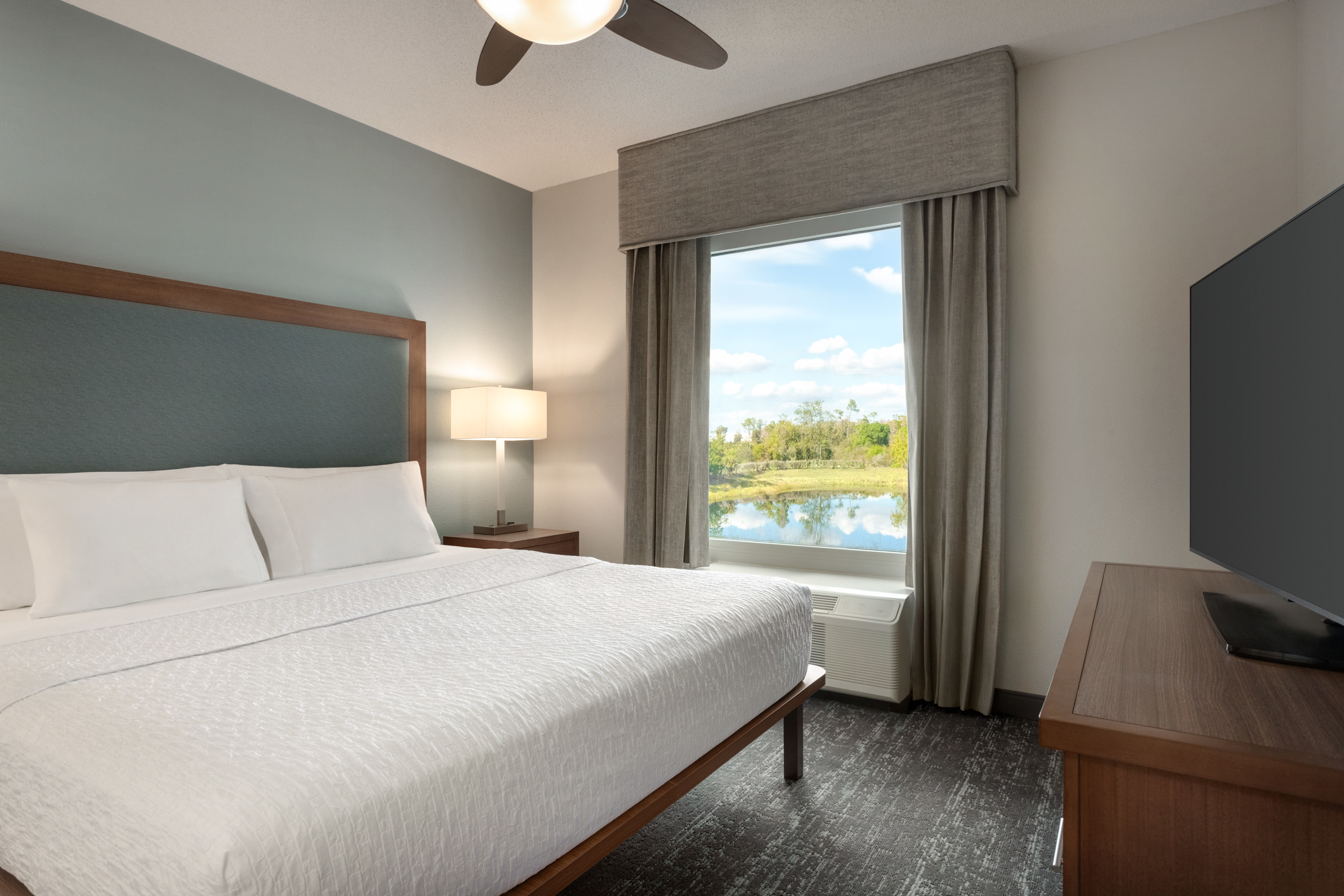Suite with a cozy king sized bed and flat screen TV