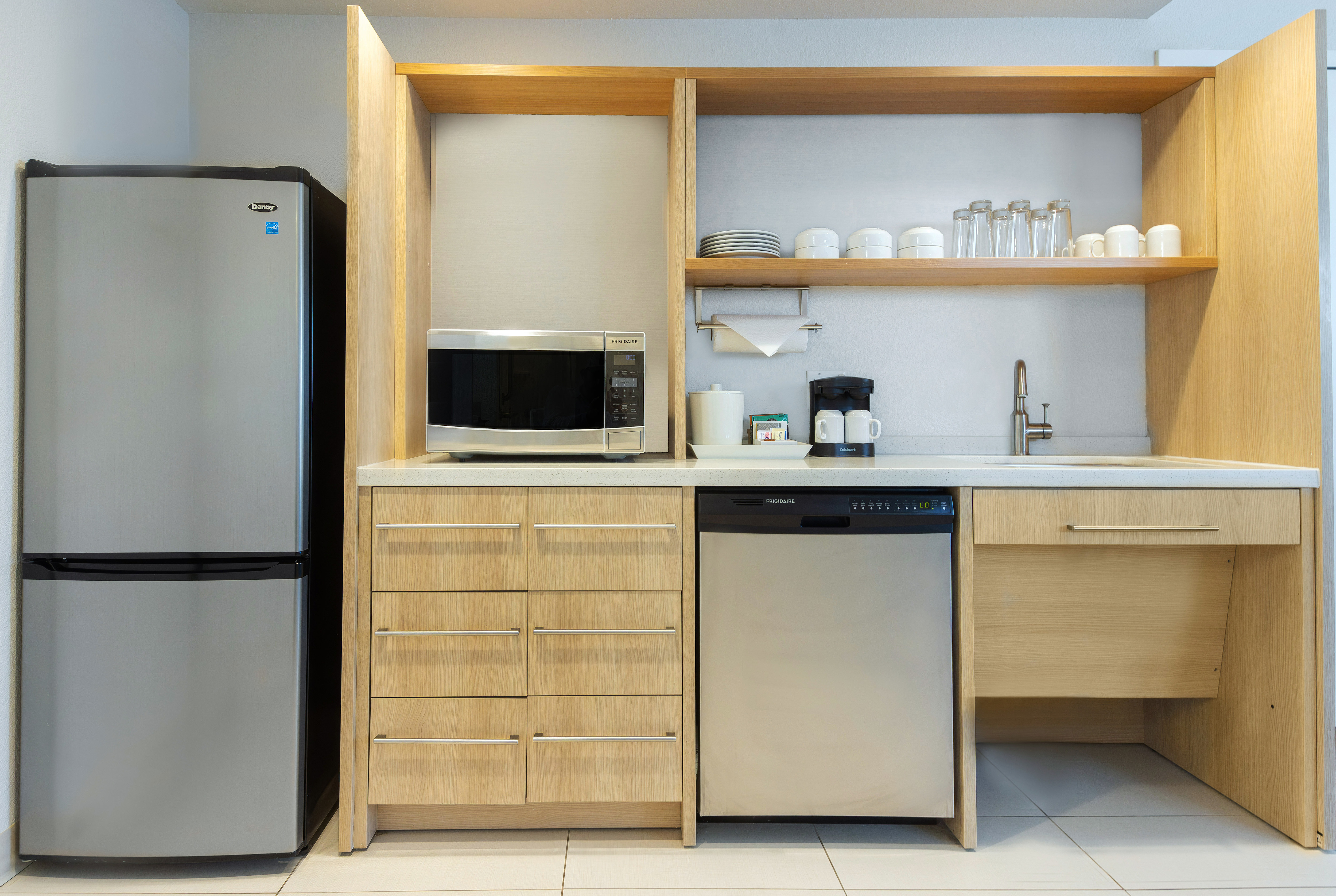 Accessible full kitchen area with dishwasher, refrigerator, microwave