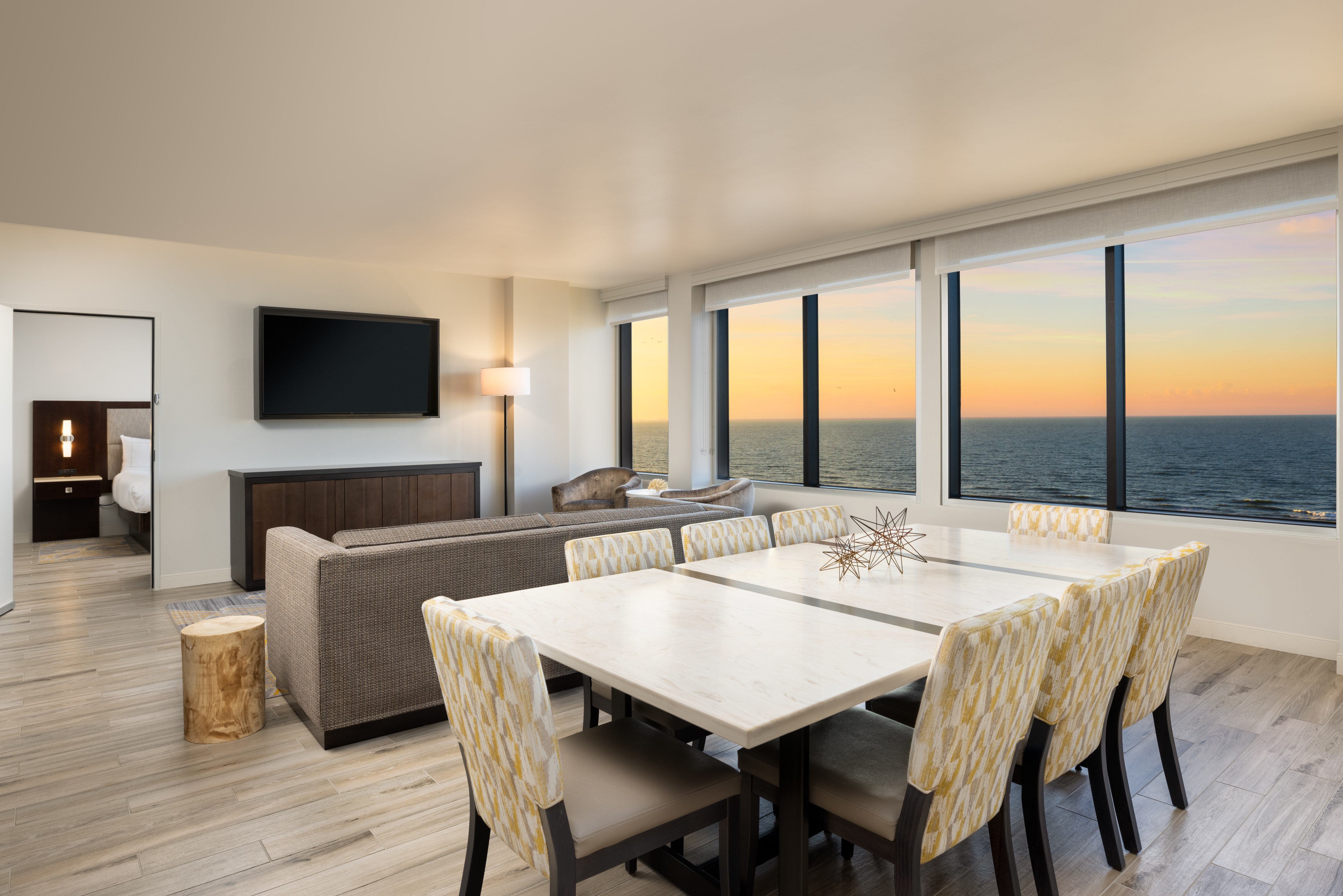 Presidential suite living area with views of the Gulf of Mexico and the open door of the connecting bedroom which has one king bed