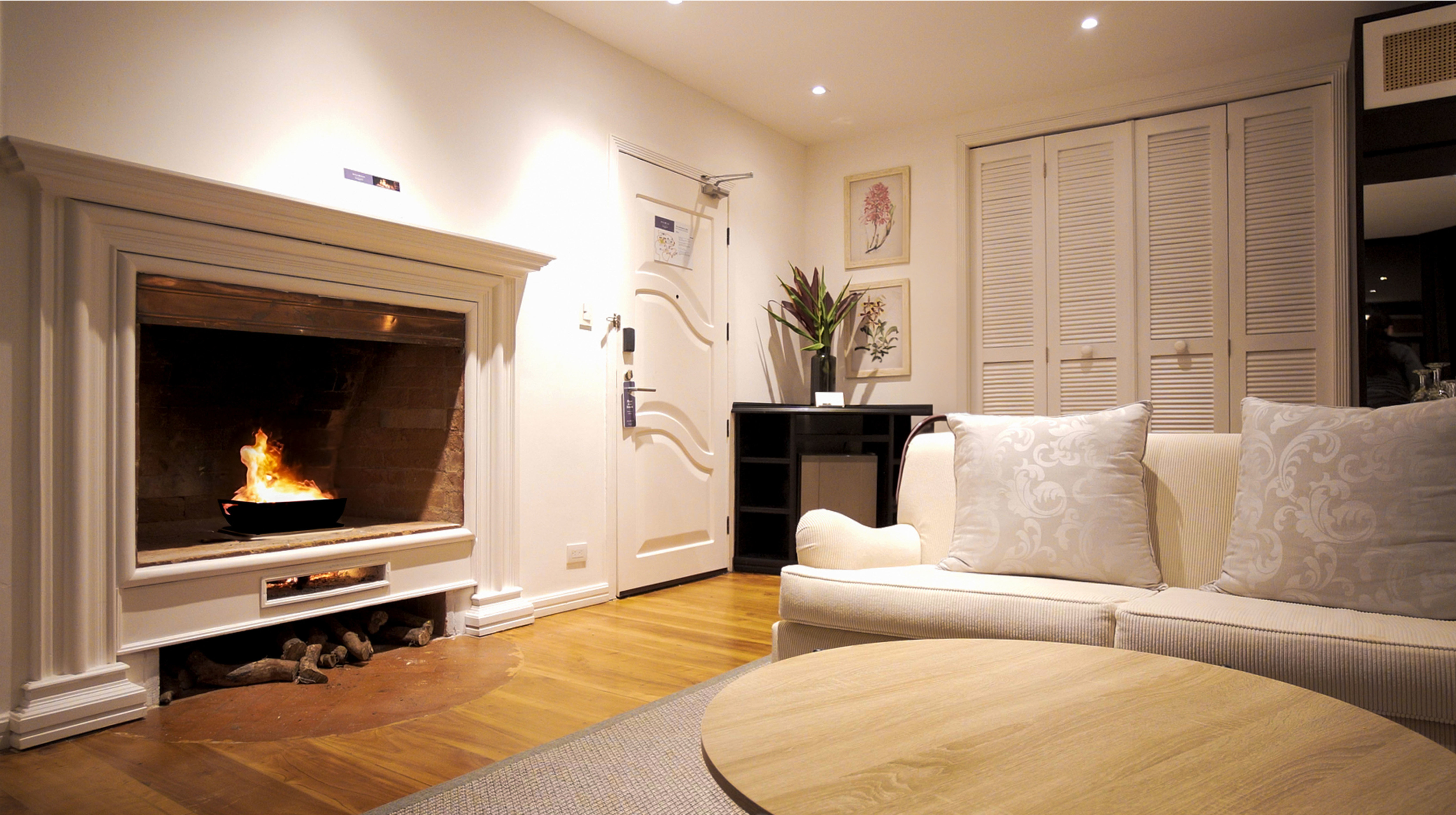 Living room in villa with sofa and fireplace.