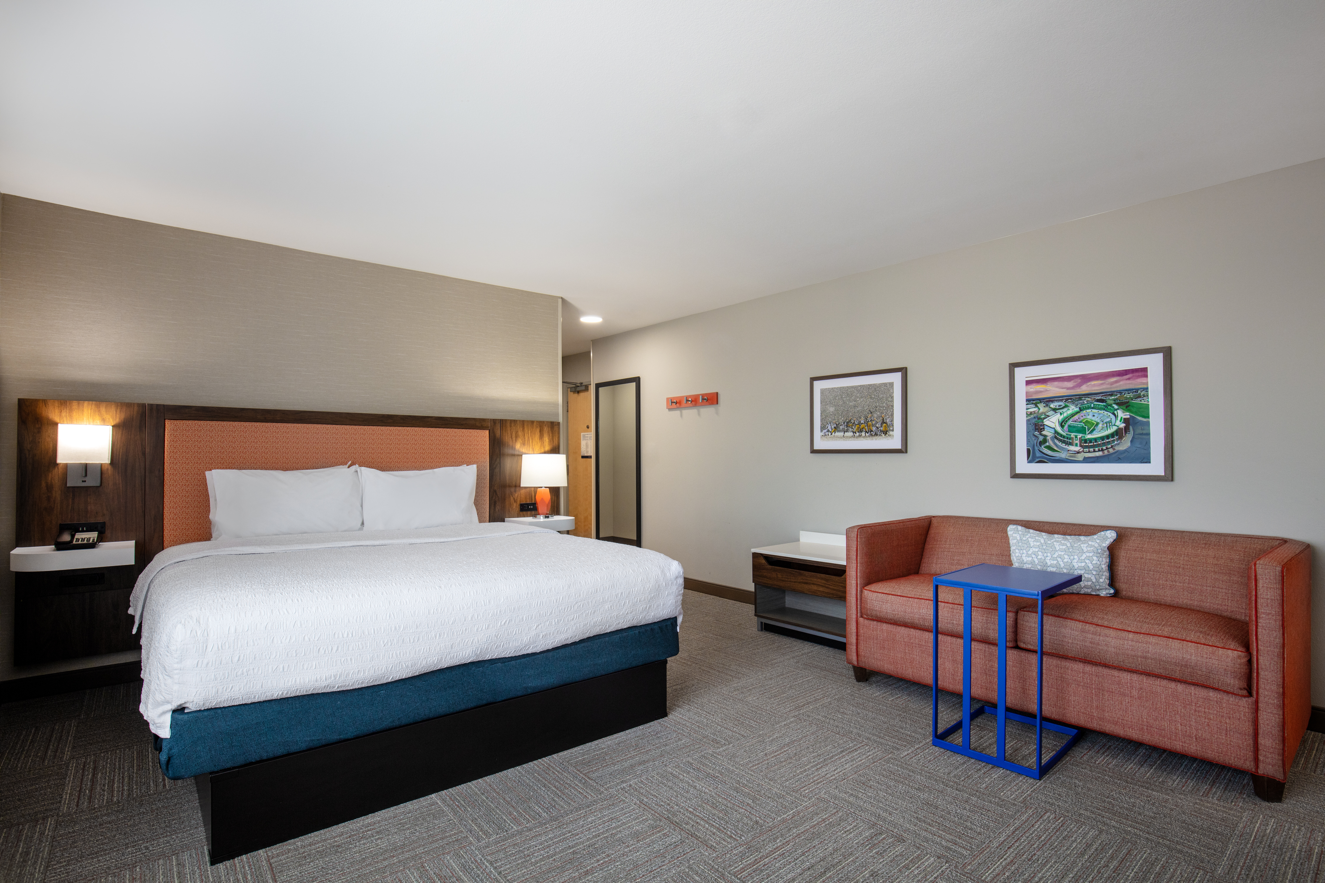 Large Bed in a Guest Room with Sofa and a Small Table