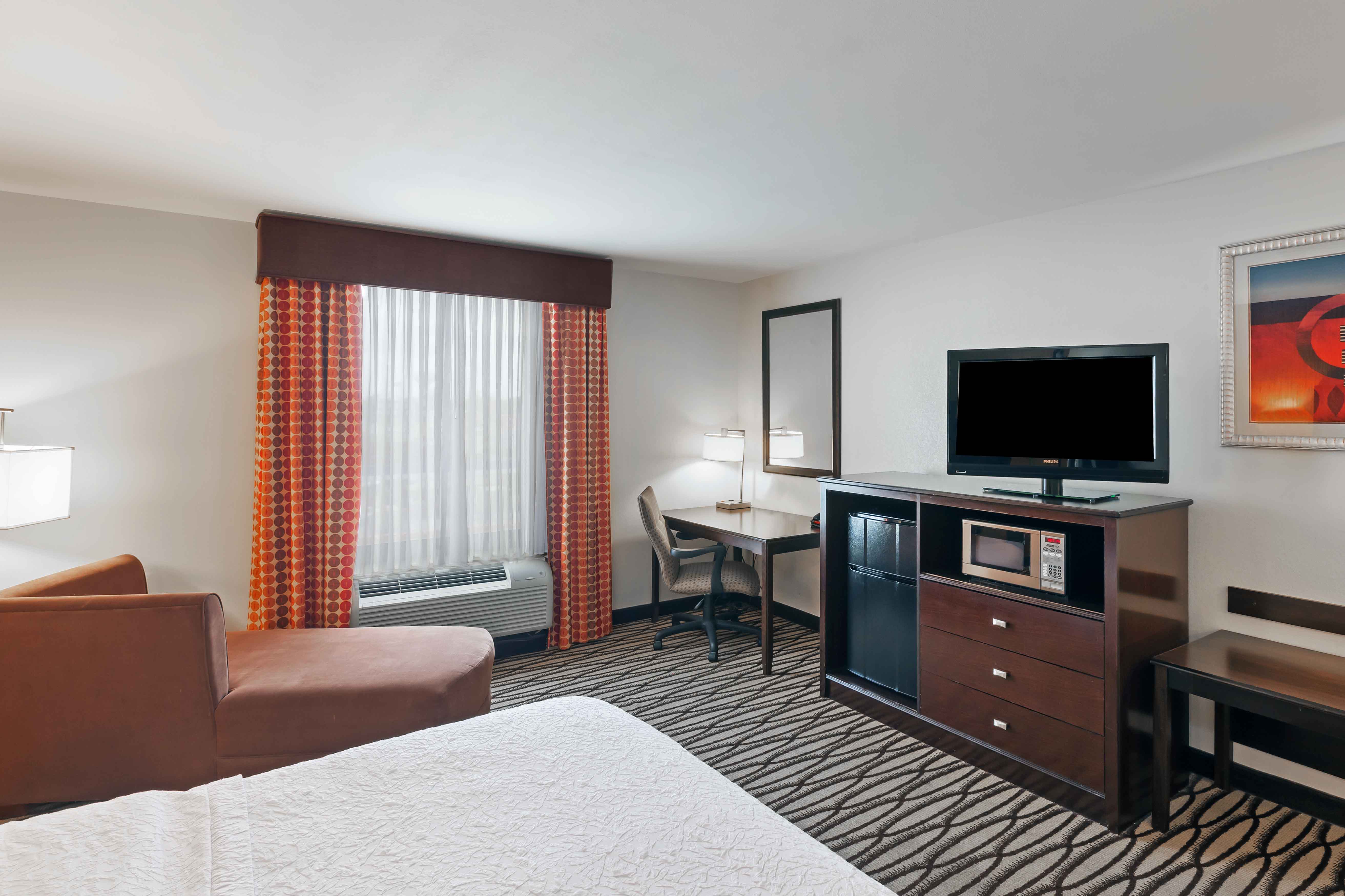 Room with Lounge Chair, Work Desk, and TV