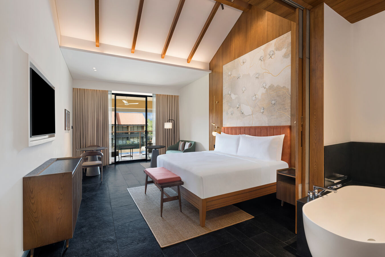 Guest Room with a Comfortable Bed, Bathtub, and Lounge Area