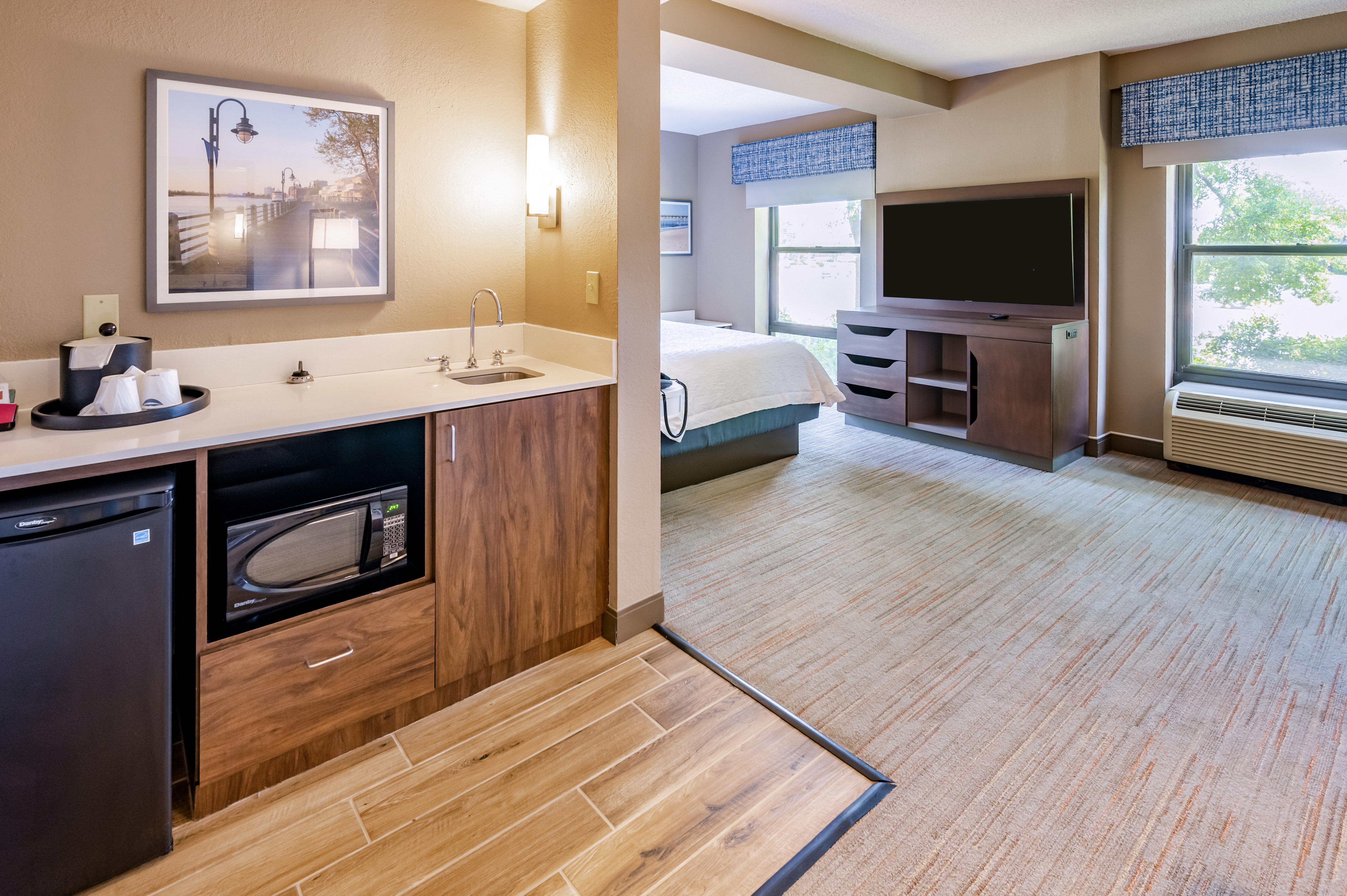 Wet Bar and HDTV in a Guest Room with a Large Bed