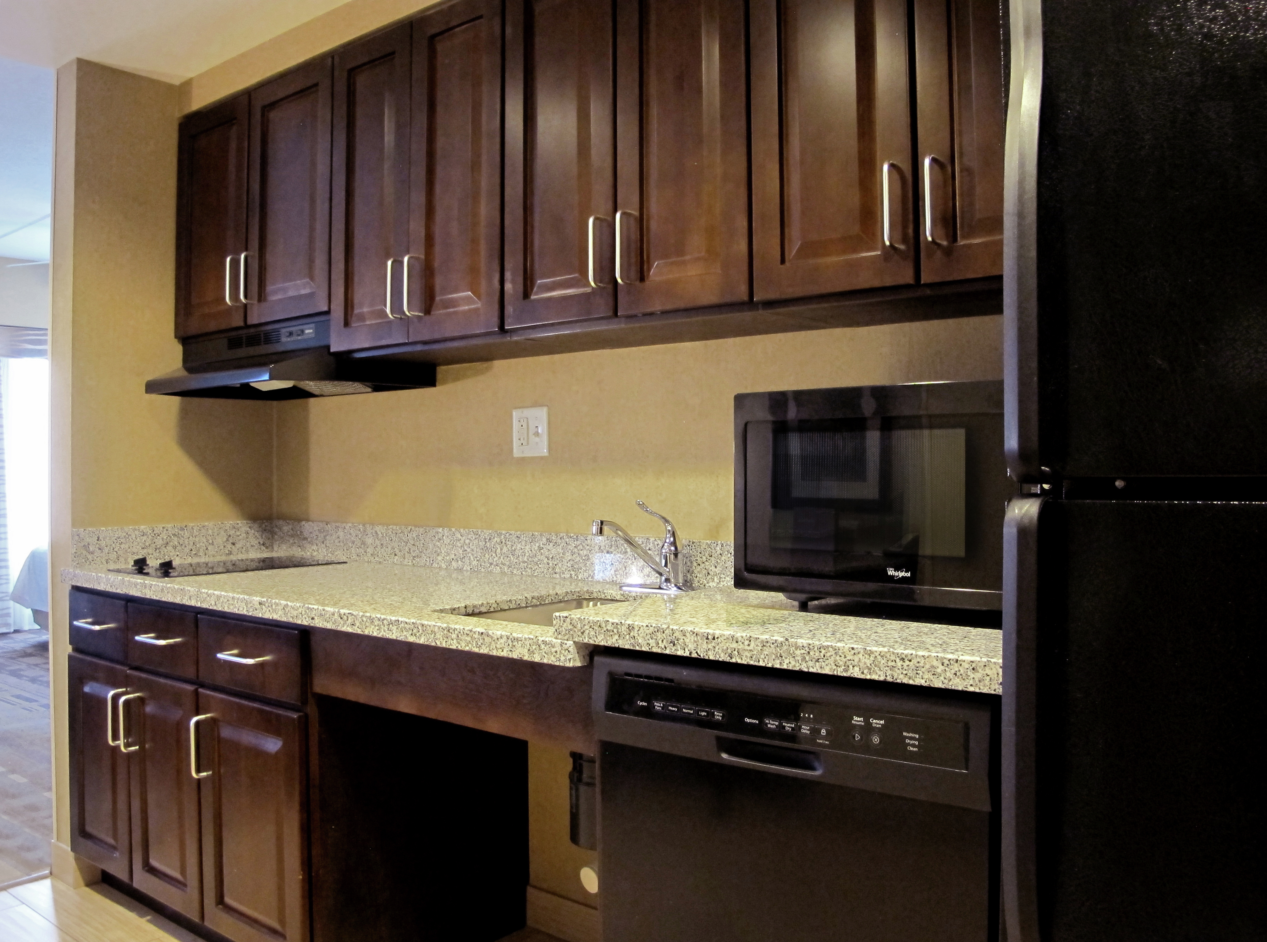 Kitchen with Dark Wood Cabinets and Mobility Accessible Counter