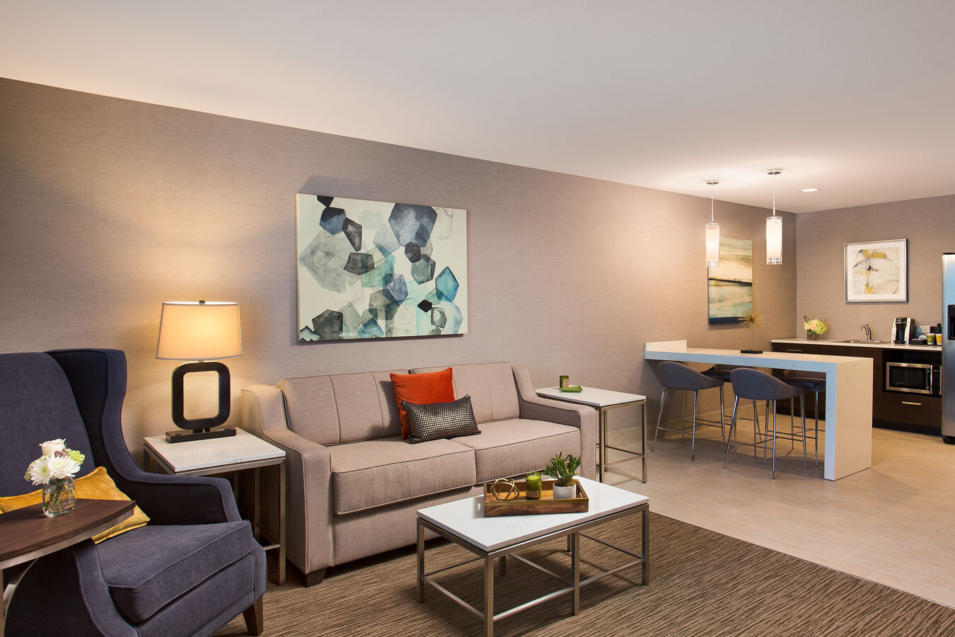 Junior Suite Living Room With Armchair, Side Tables, Wall Art, Sofa Bed, Dining Table With Seating for Two and Kitchen