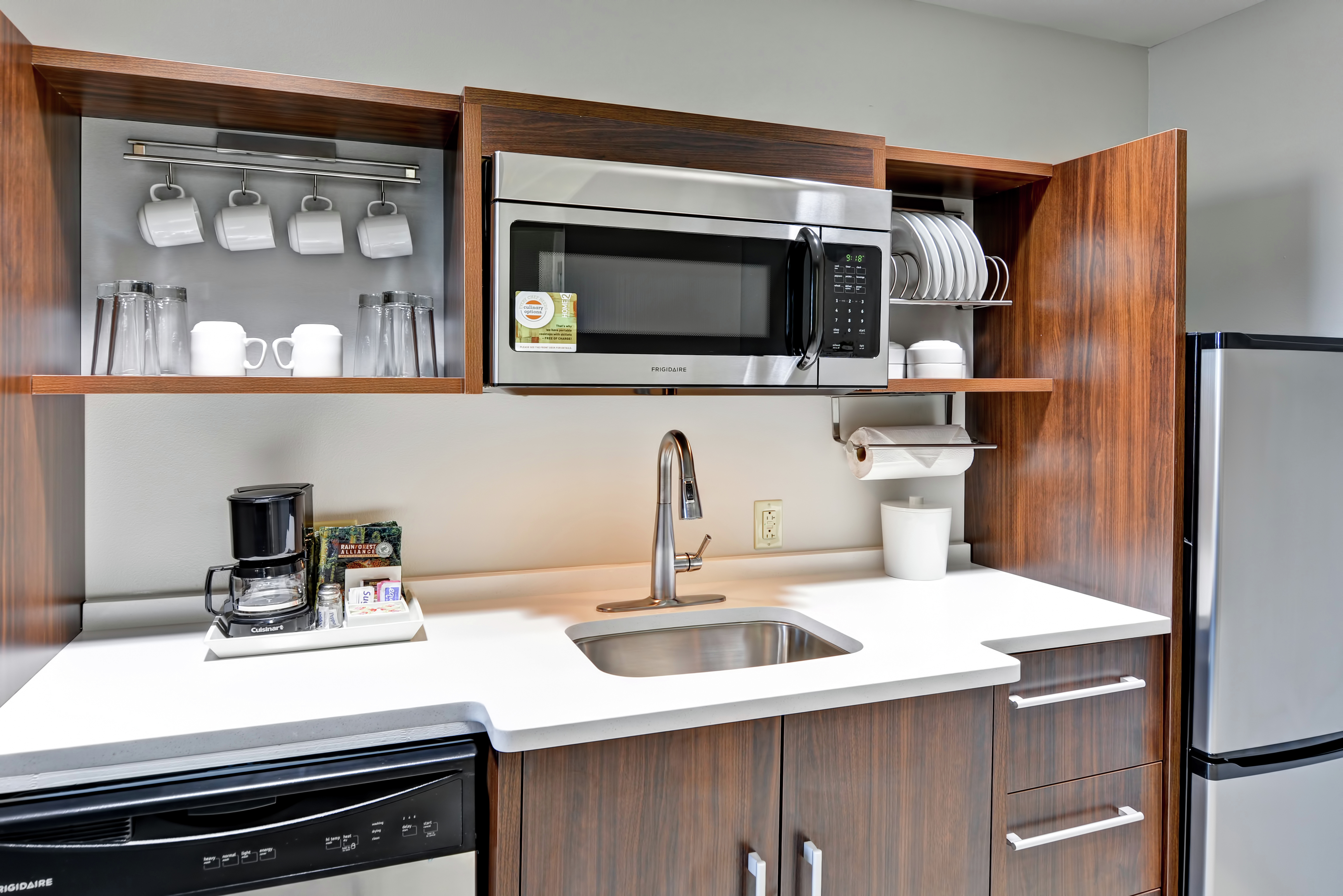 Suite Kitchen with Fridge, Dishwasher, Microwave, Sink and Dishes