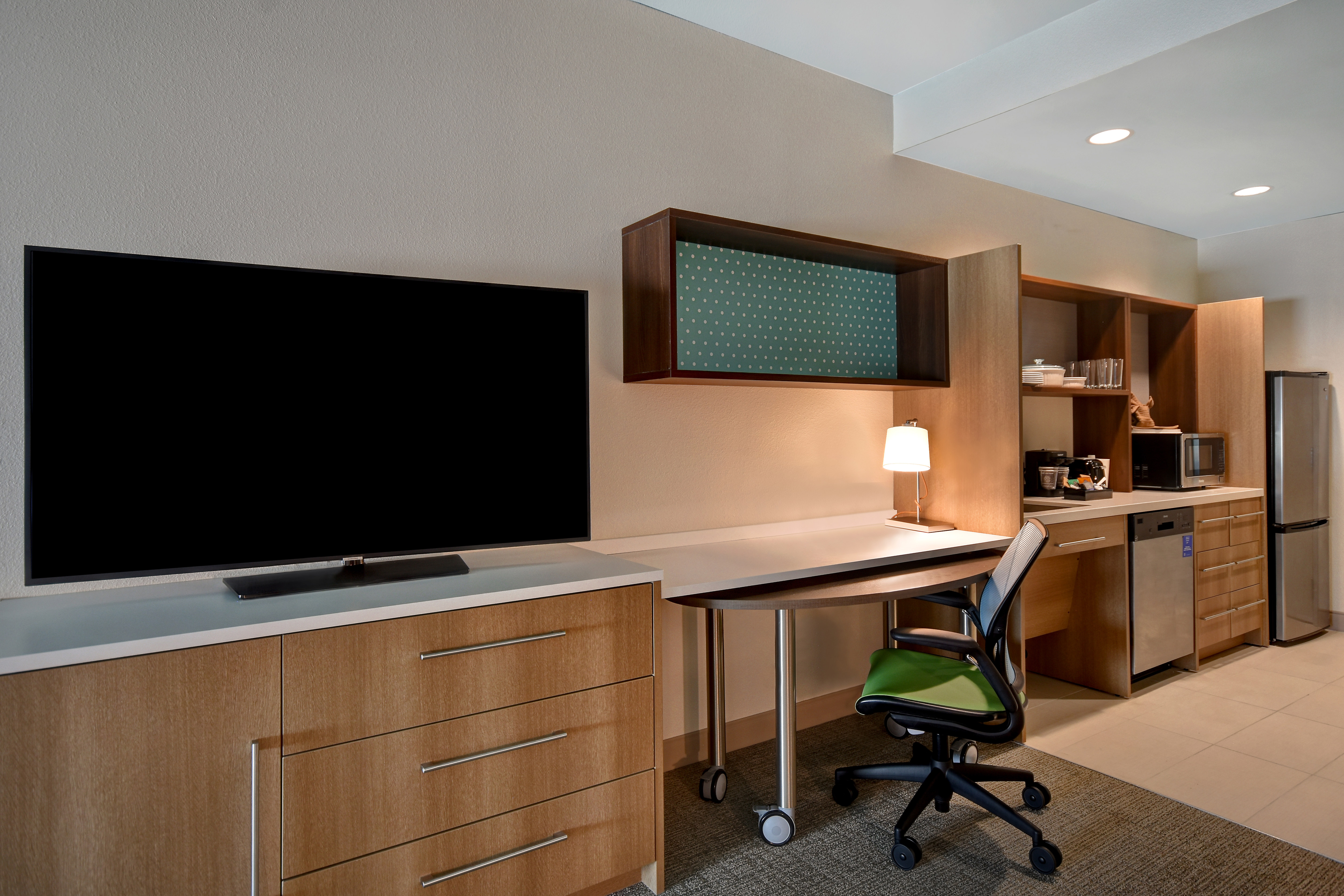 guest room work desk television and kitchen