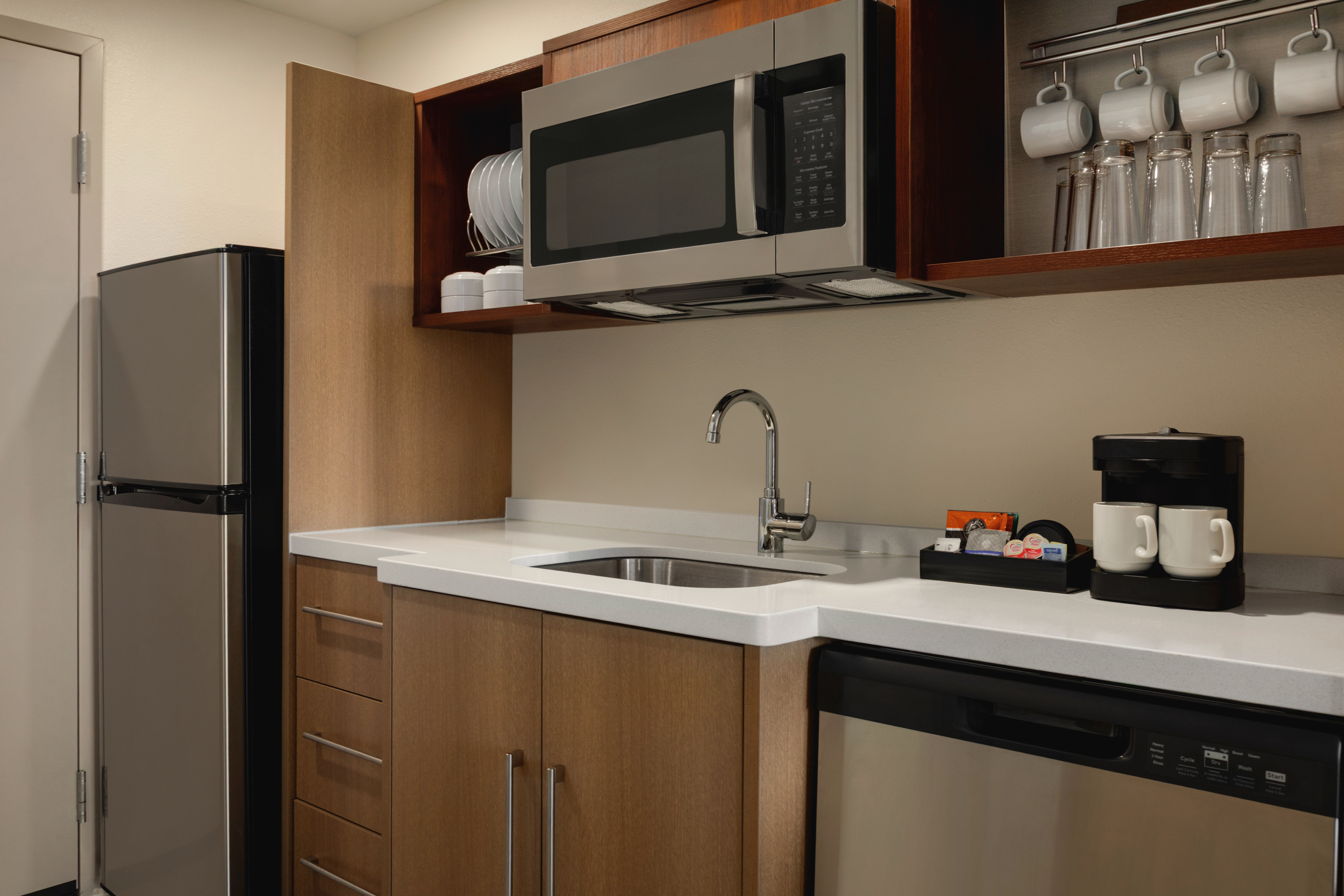 Convenient kitchen with a dishwasher and a full sized fridge