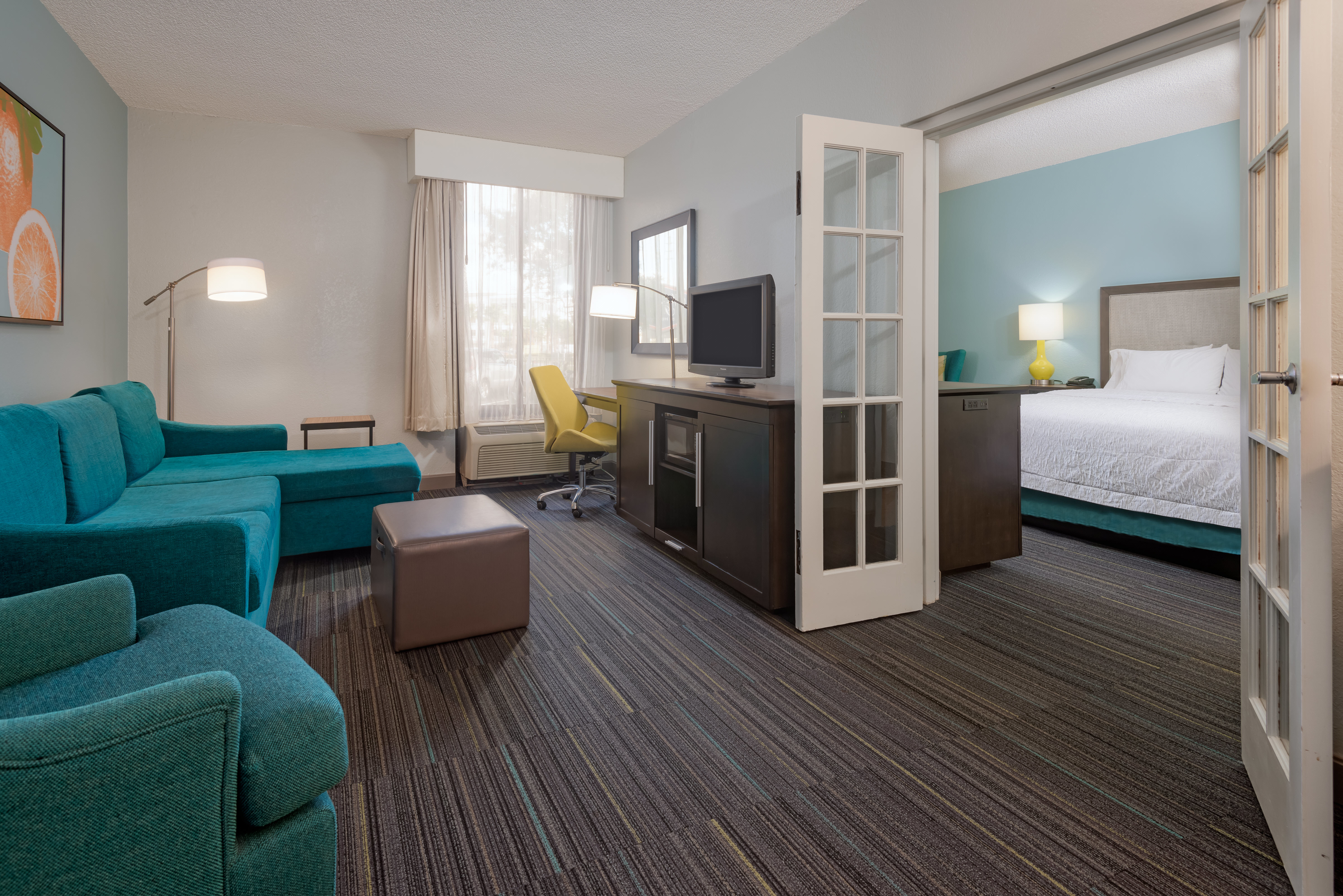 Suite Living Room and Bedroom Separated by French Doors