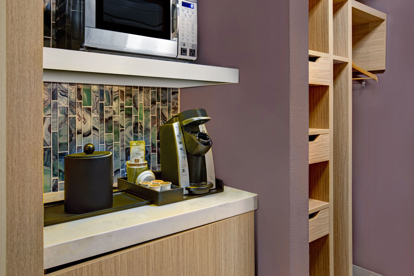 guest room entry with closet and snacks and coffee