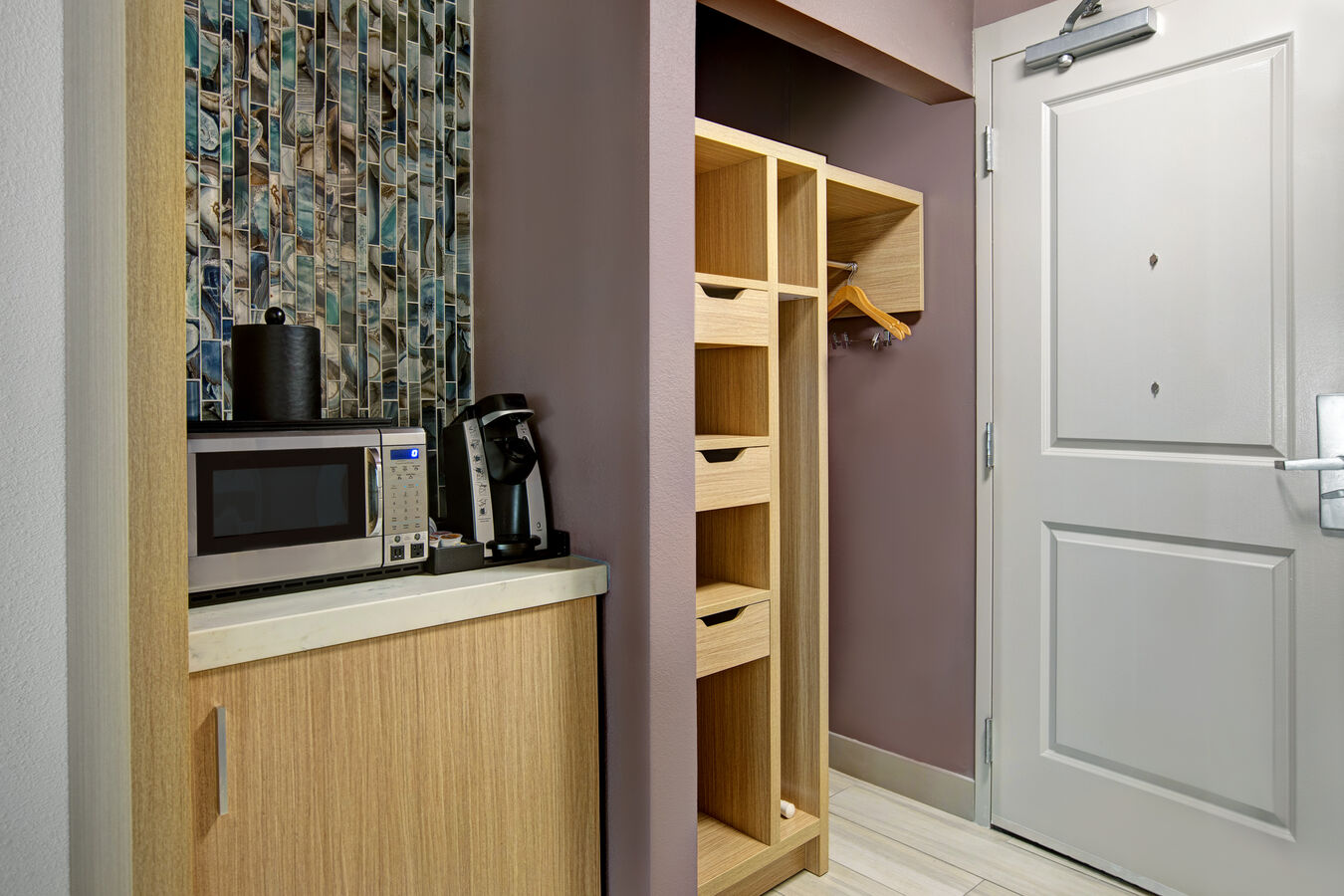 guest room entry with closet and bar