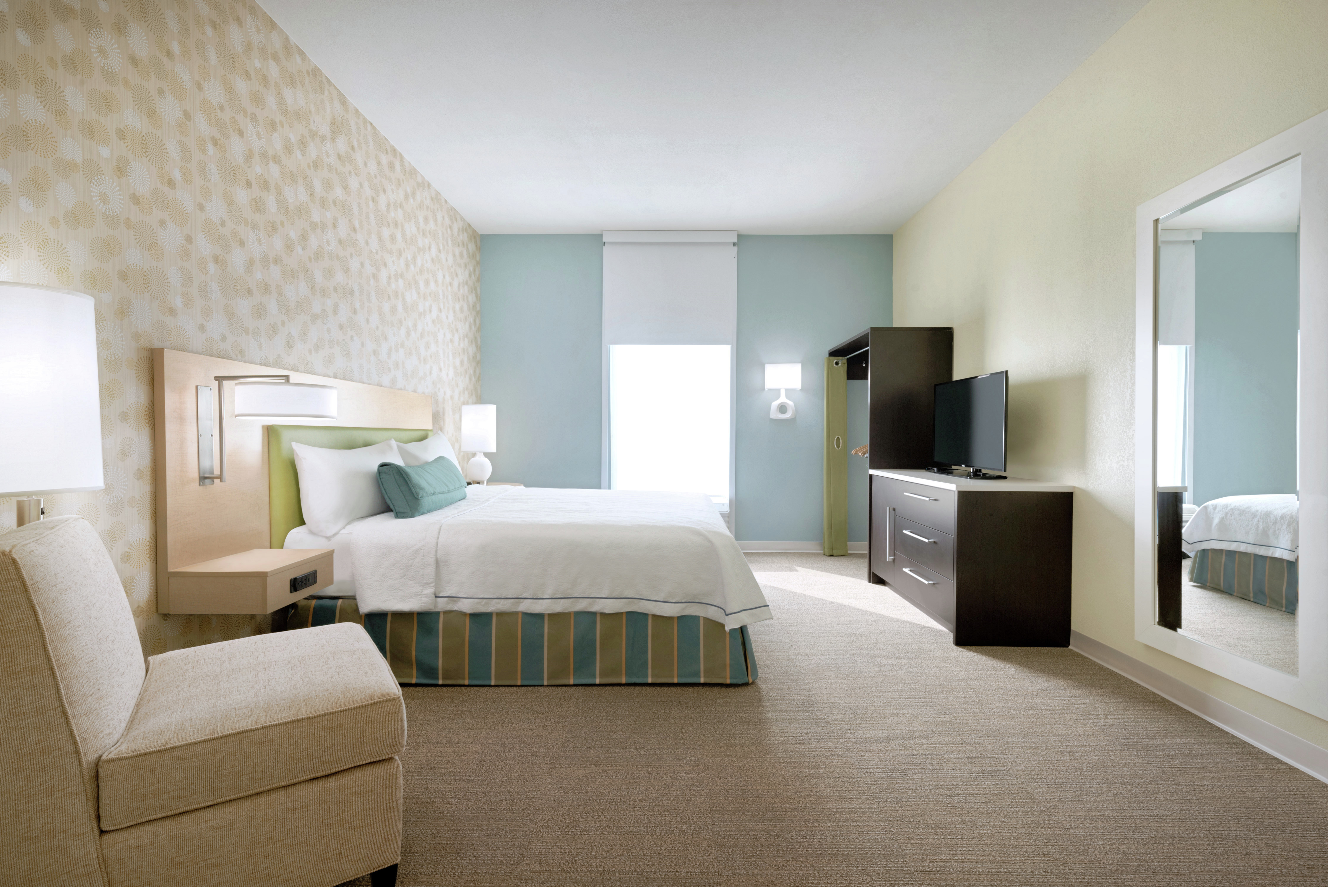 Accessible Suite Bedroom with King Bed, TV, and Lounge Chair