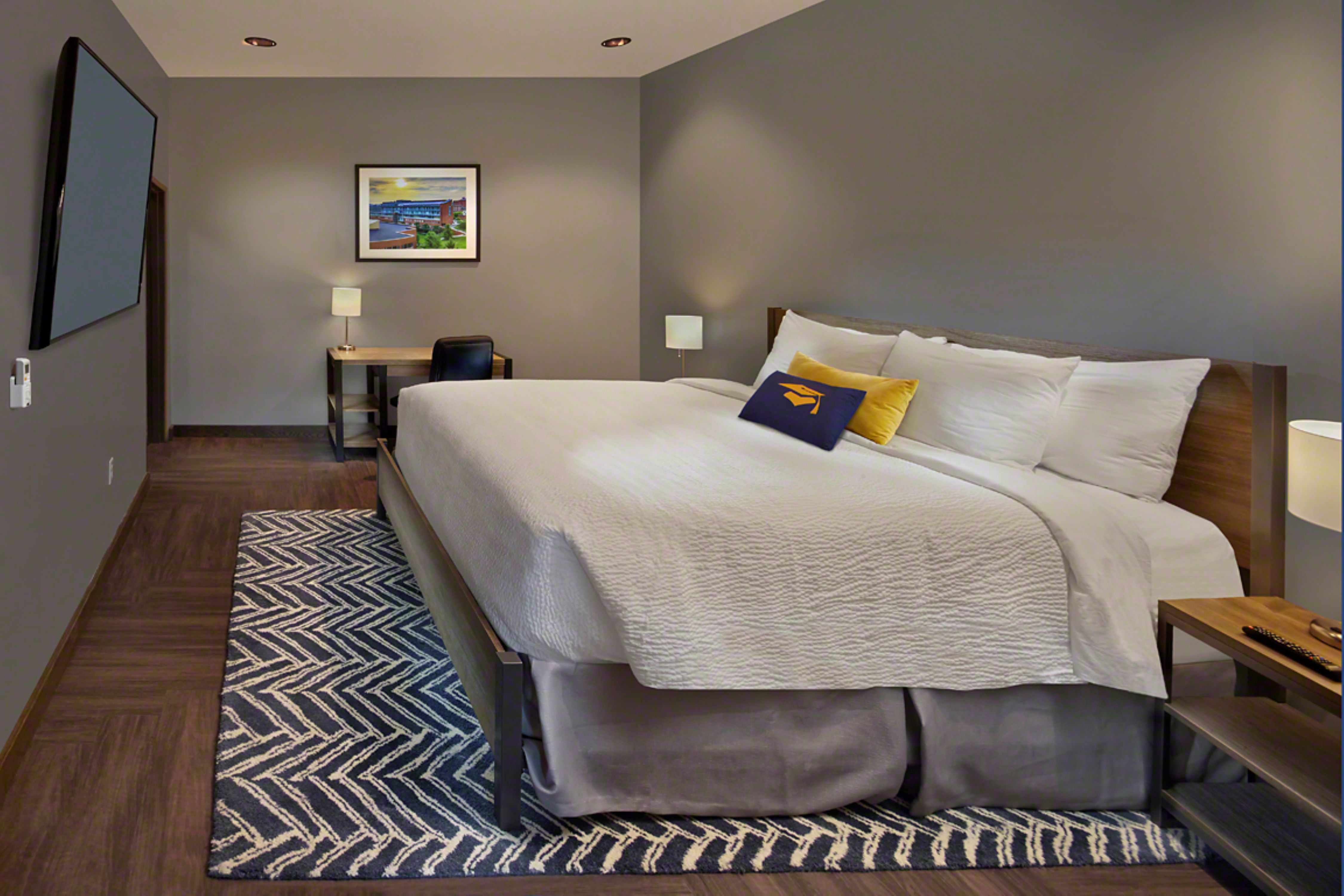Accessible suite bedroom with wall mounted TV and work desk
