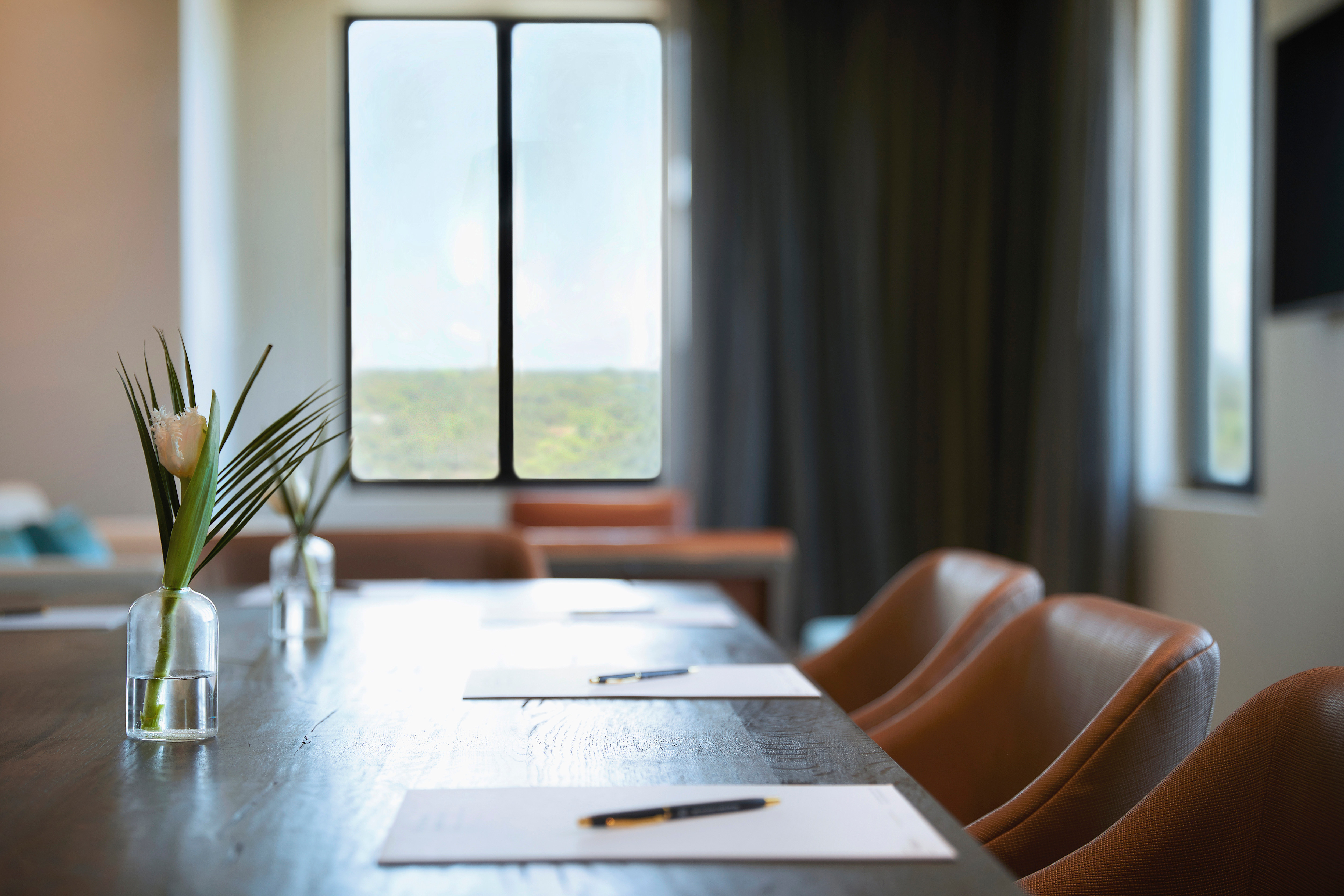 Closeup of chairs at a table with a window in the background