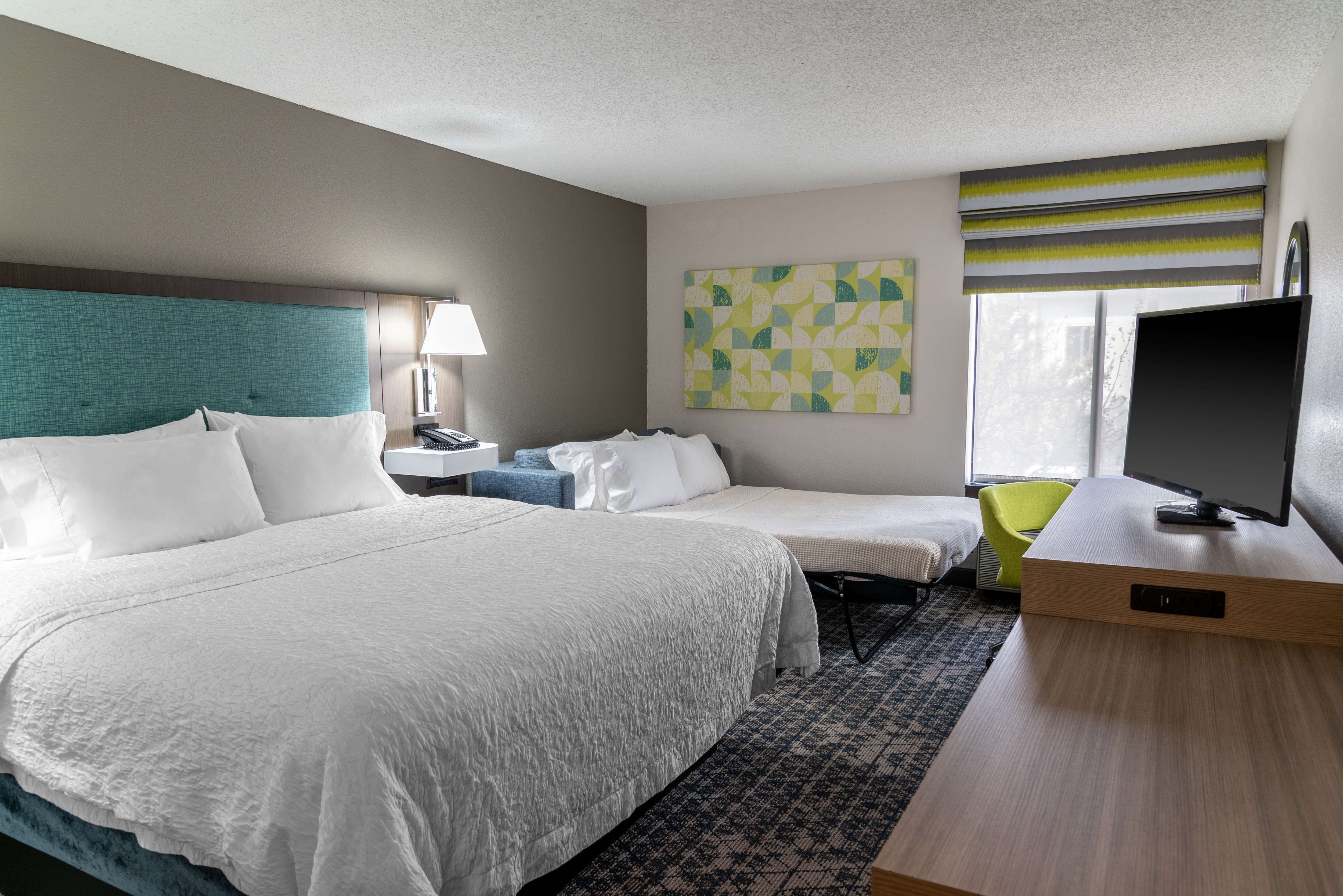 Large Bed Desk HDTV and Sofa Bed in Guest Room
