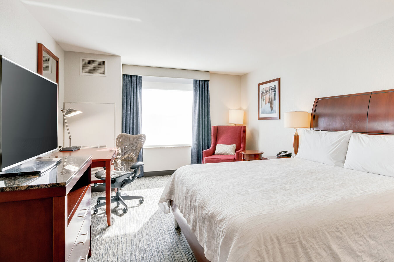 King-Size Bed, Work Desk with Ergonomic Chair, and Flat Screen TV in Standard King Guest Room